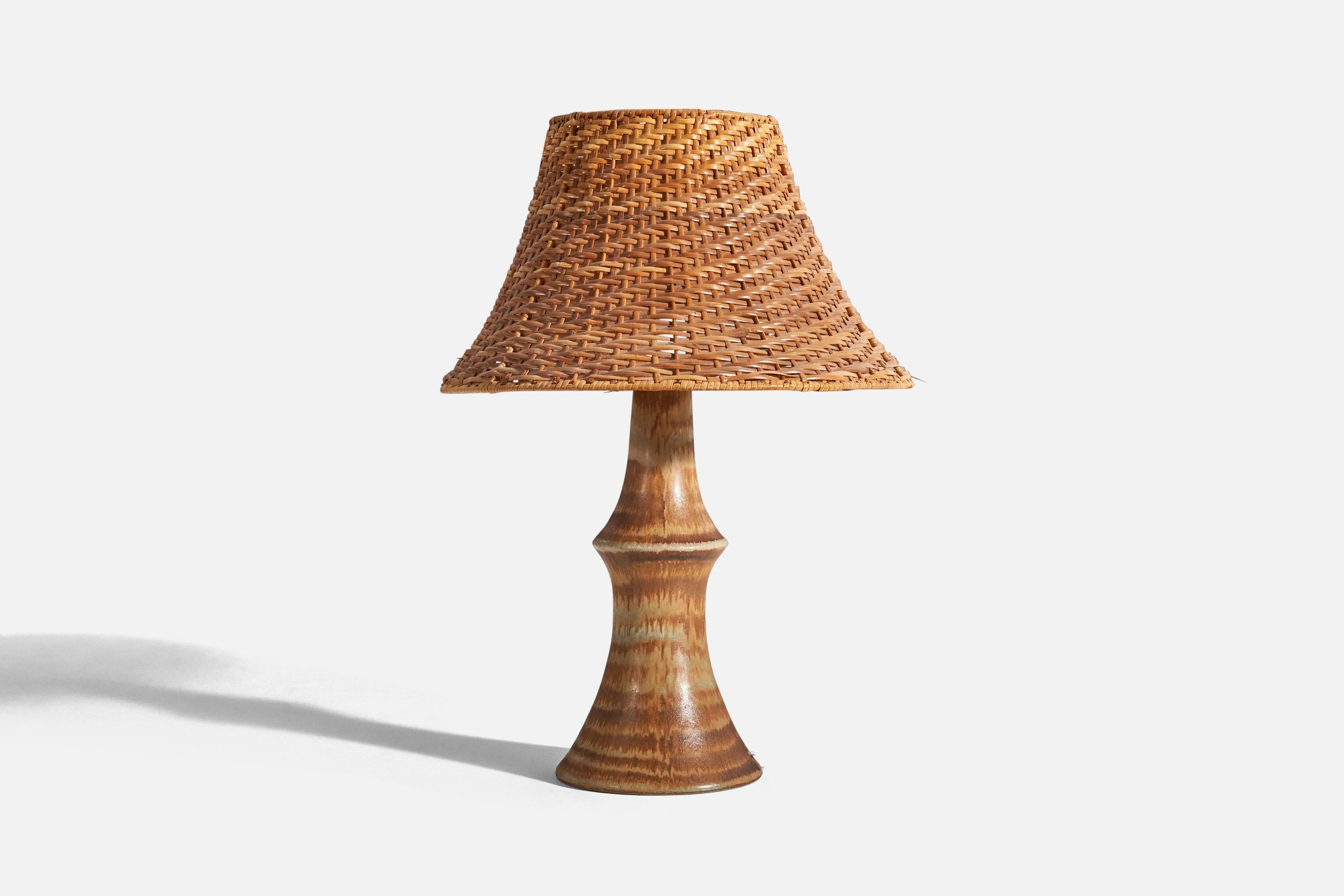 A brown-glazed stoneware table lamp designed by Bruno Karlsson and produced by Ego Stengods, Sweden, c. 1960s.

Sold with lampshade. 
Dimensions of lamp (inches) : 15.06 x 6.25 x 6.25 (height x width x depth)
Dimensions of shade (inches) : 6.75