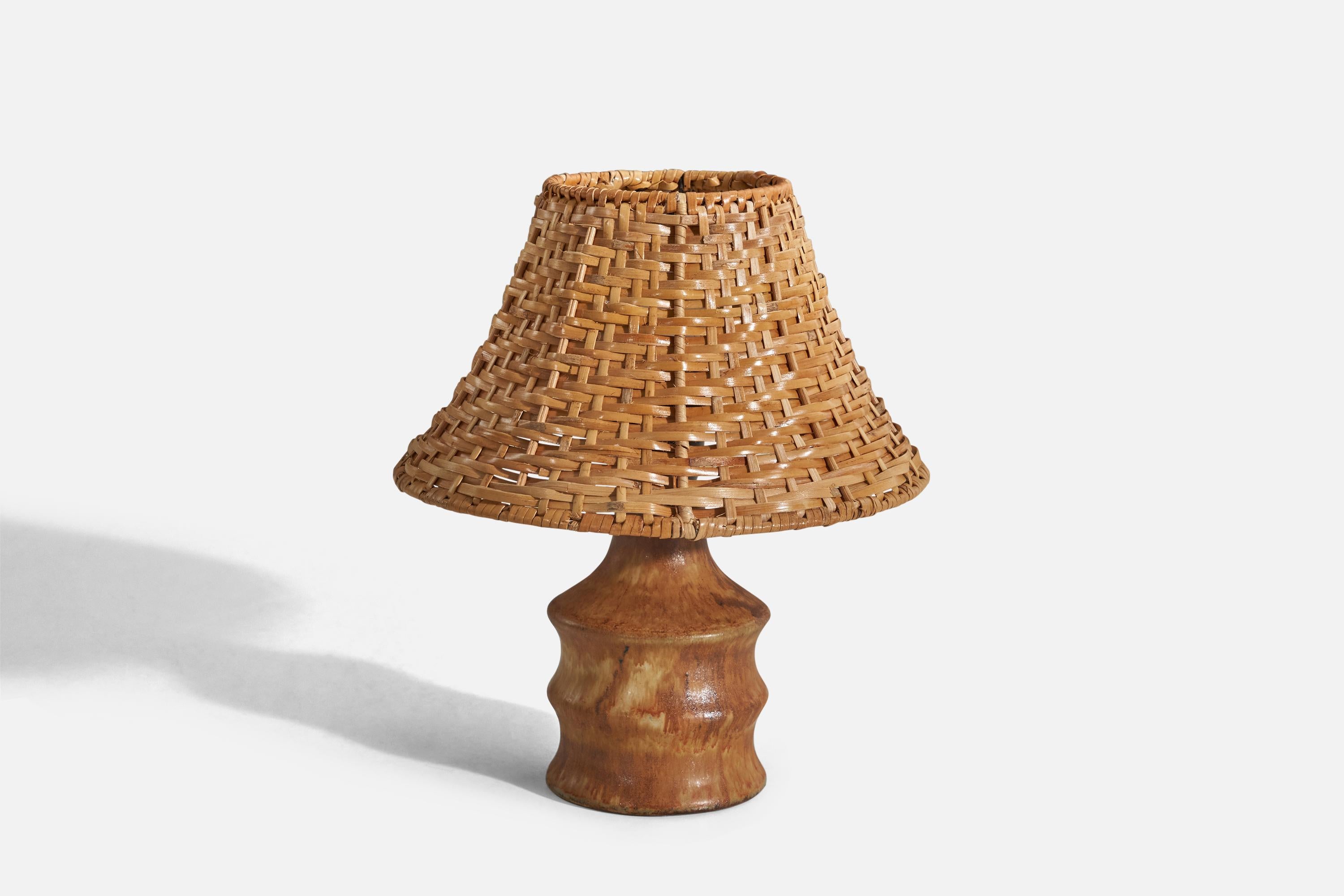A brown-glazed stoneware table lamp designed by Bruno Karlsson and produced by Ego Stengods, Sweden, c. 1960s.

Sold with rattan lampshade. 
Dimensions of lamp (inches) : 6.93 x 3.7 x 3.7 (Height x Width x Depth)
Dimensions of shade (inches) :