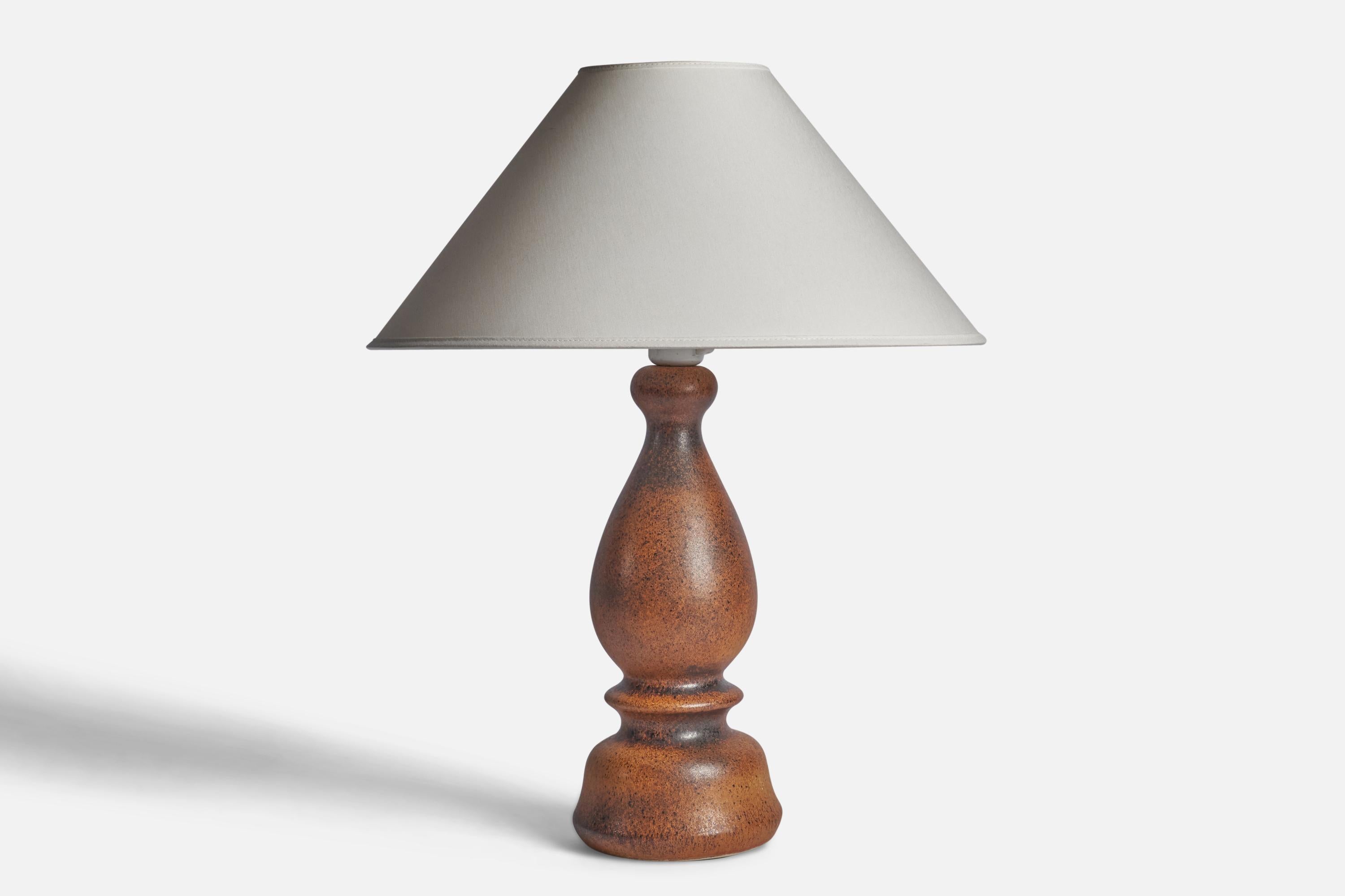 A brown-glazed stoneware table lamp designed by Bruno Karlsson and produced by Ego Stengods, Sweden, 1960s.

Dimensions of Lamp (inches): 15.5” H x 5.5” Diameter
Dimensions of Shade (inches): 4.5” Top Diameter x 16” Bottom Diameter x 7.25”