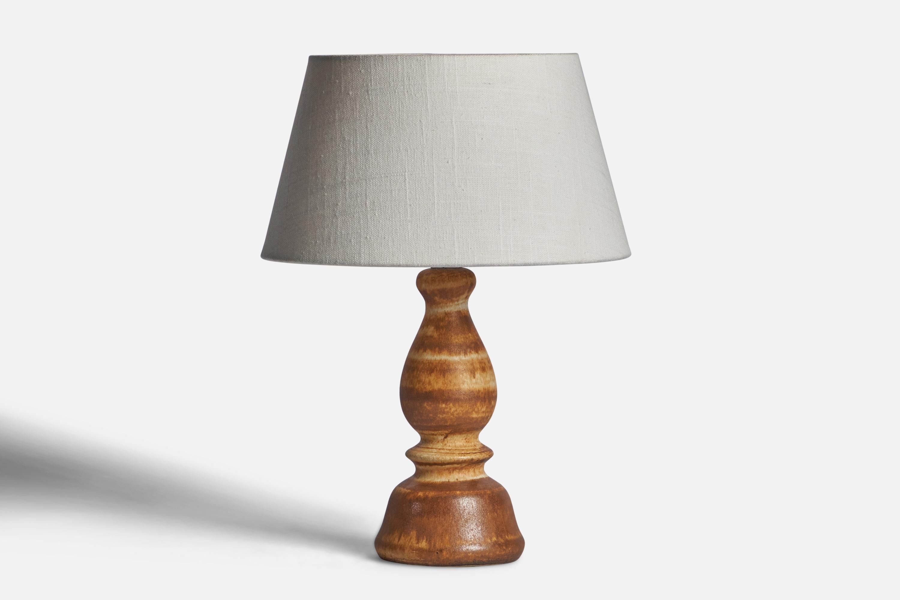 A brown and beige-glazed table lamp designed by Bruno Karlsson and produced by Ego Stengods, Sweden, 1960s.

Dimensions of Lamp (inches): 10.85” H x 4.15” Diameter
Dimensions of Shade (inches): 7” Top Diameter x 10” Bottom Diameter x