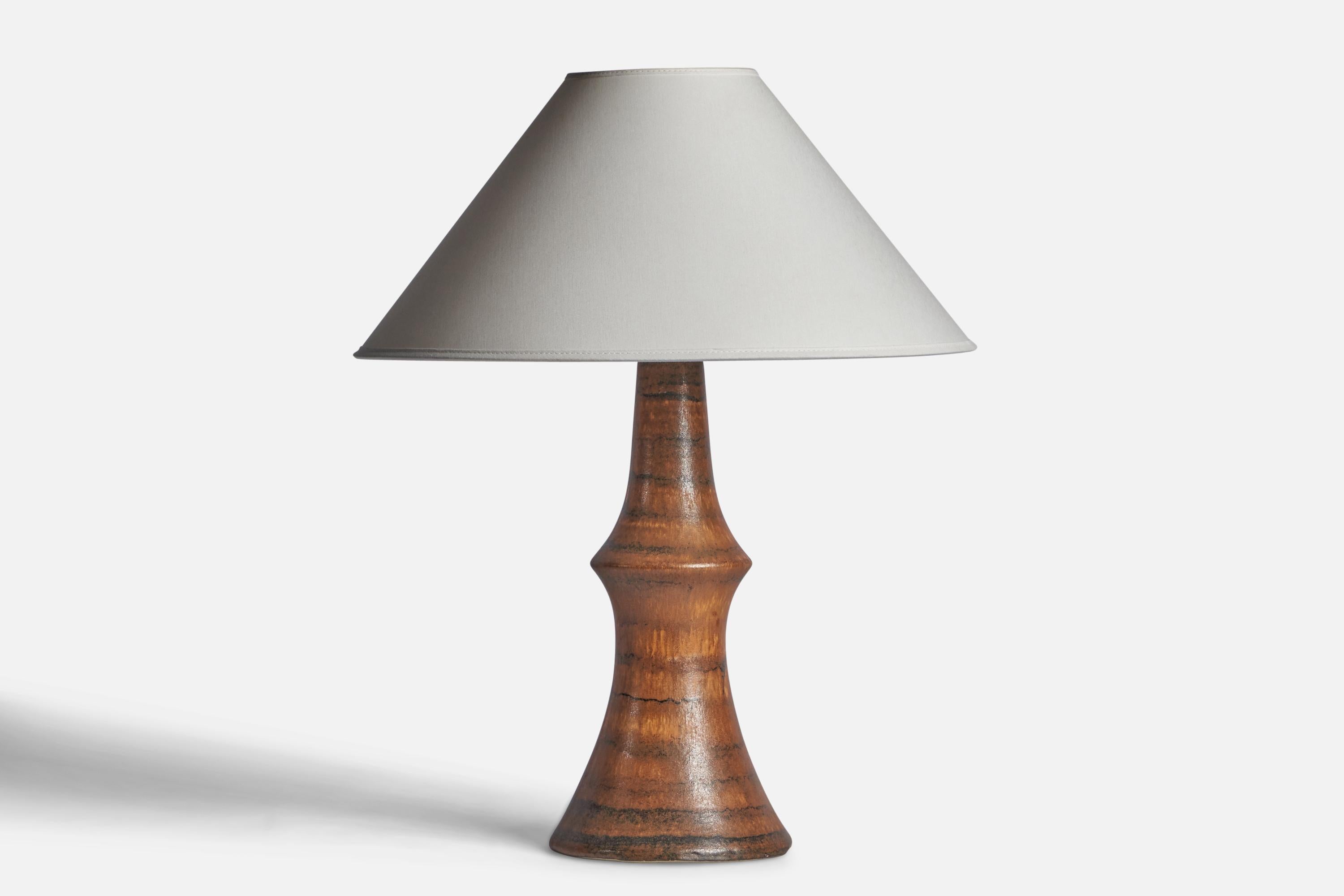 A brown-glazed stoneware table lamp designed by Bruno Karlsson and produced by Ego Stengods, Sweden, c. 1960s.

Dimensions of Lamp (inches): 15.75” H x 6.2” Diameter
Dimensions of Shade (inches): 4.5” Top Diameter x 16” Bottom Diameter x 7.25”