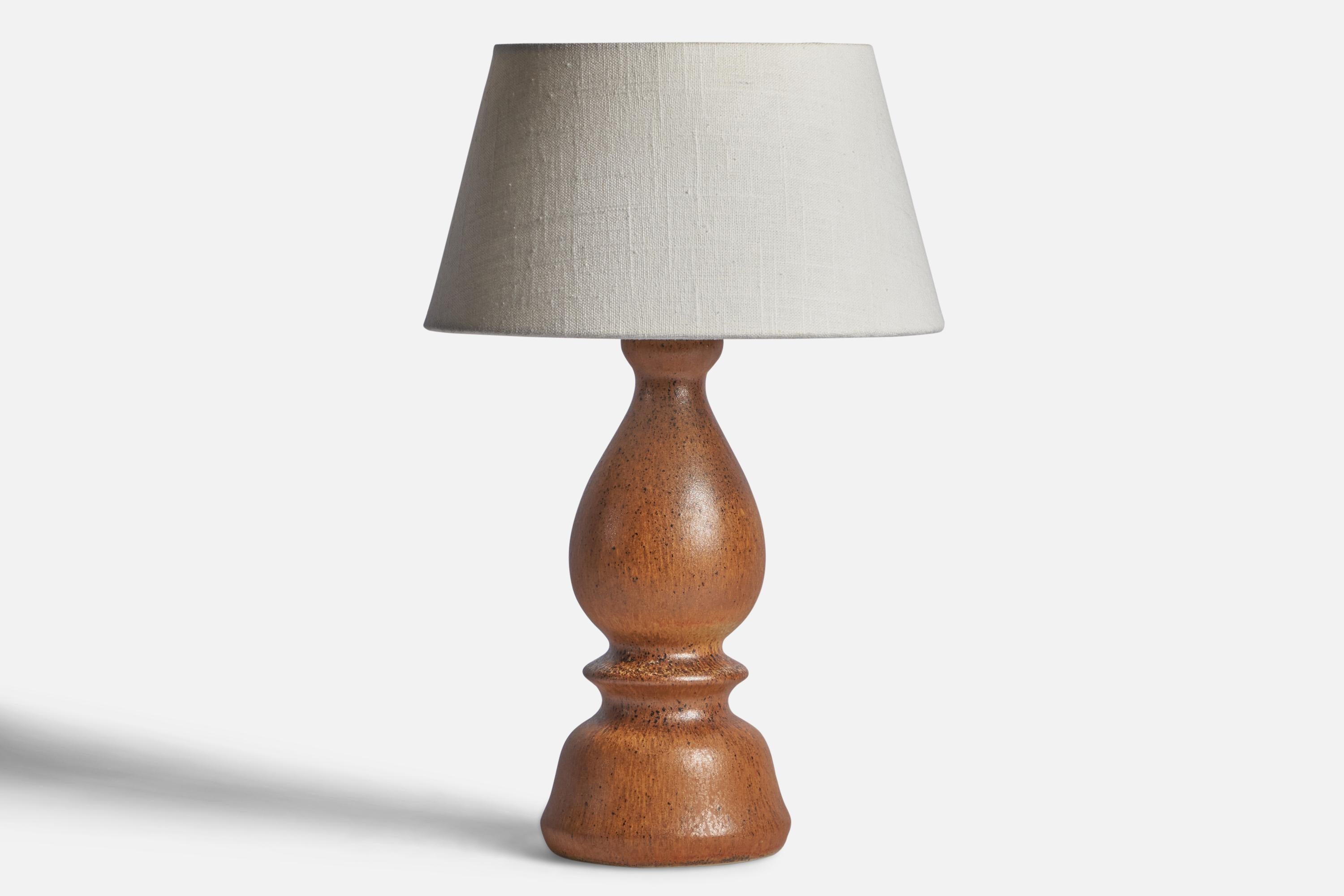 A brown-glazed stoneware table lamp designed by Bruno Karlsson and produced by Ego Stengods, Sweden, c. 1960s.

Dimensions of Lamp (inches): 12.5” H x 5” Diameter

Dimensions of Shade (inches): 7” Top Diameter x 10” Bottom Diameter x 5.5”