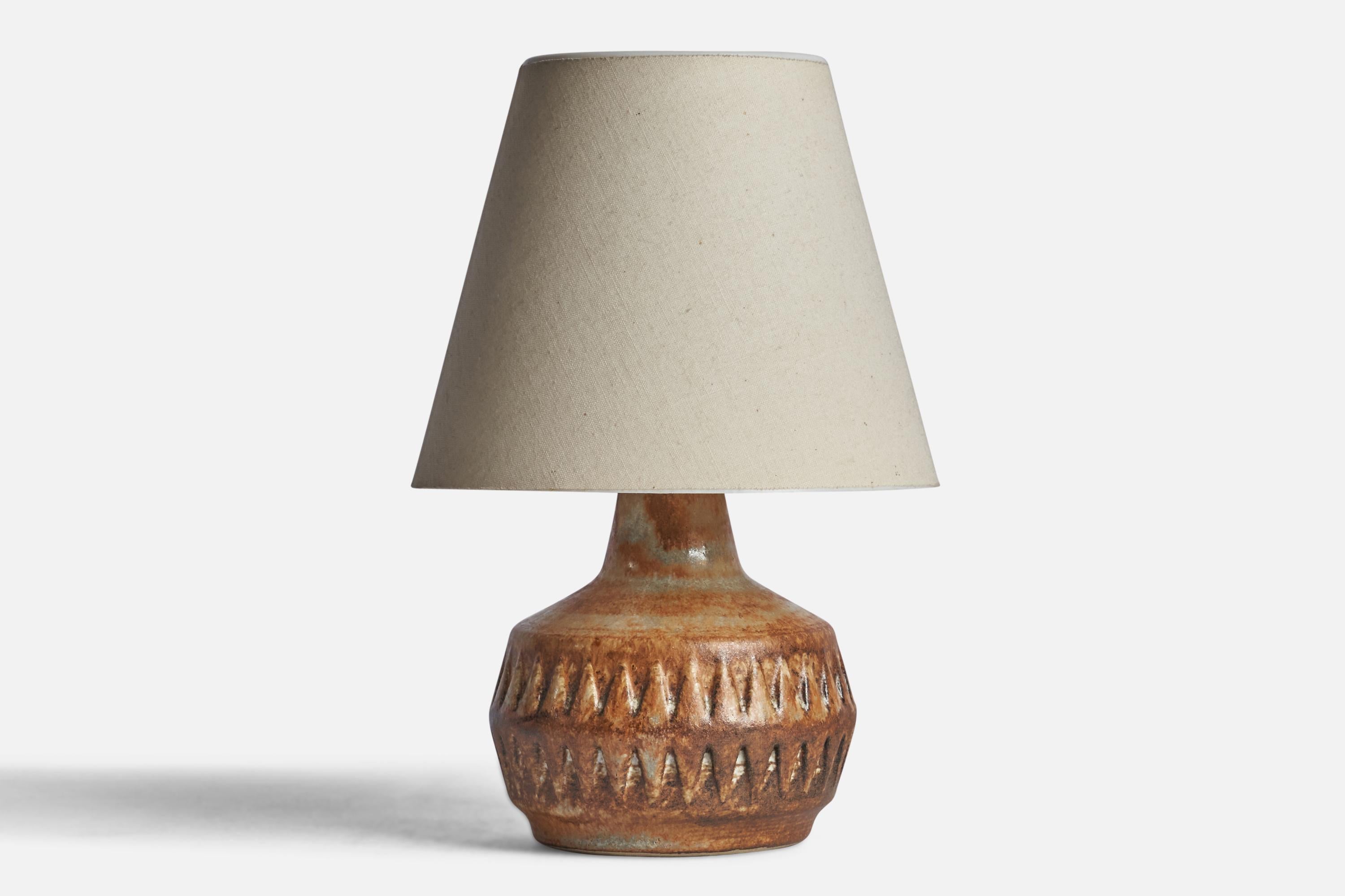 A brown-glazed stoneware table lamp designed and produced in Sweden, 1960s.

Dimensions of Lamp (inches): 7” H x 4.75” Diameter
Dimensions of Shade (inches): 3.5” Top Diameter x 6.4” Bottom Diameter x 5.5” H 
Dimensions of Lamp with Shade (inches):