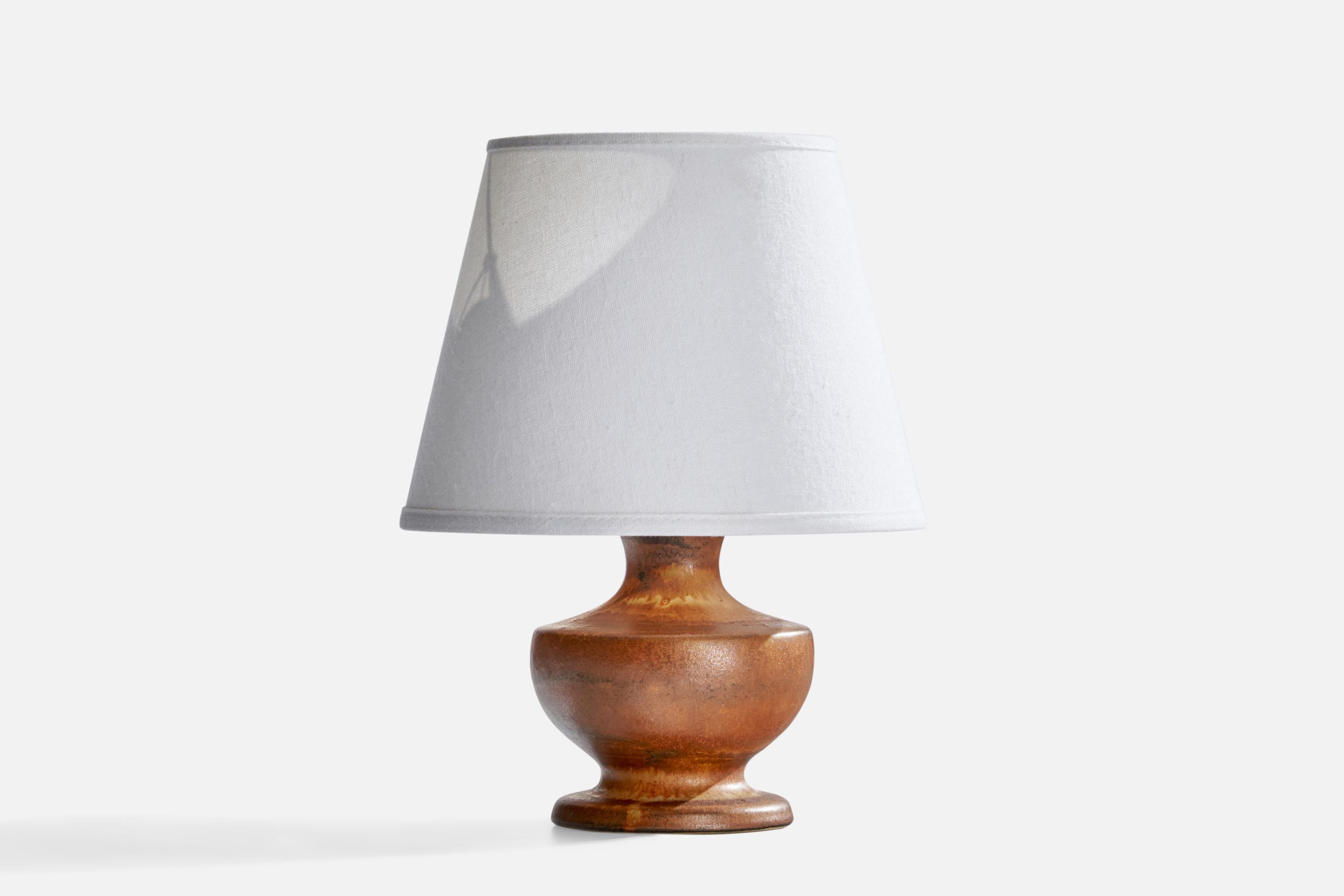 A brown-glazed stoneware table lamp designed by Bruno Karlsson and produced by Ego Stengods, Sweden, c. 1960s.

Dimensions of Lamp (inches): 7”  H x 4.5” Diameter
Dimensions of Shade (inches): 5” Top Diameter x 7.75” Bottom Diameter x 6”