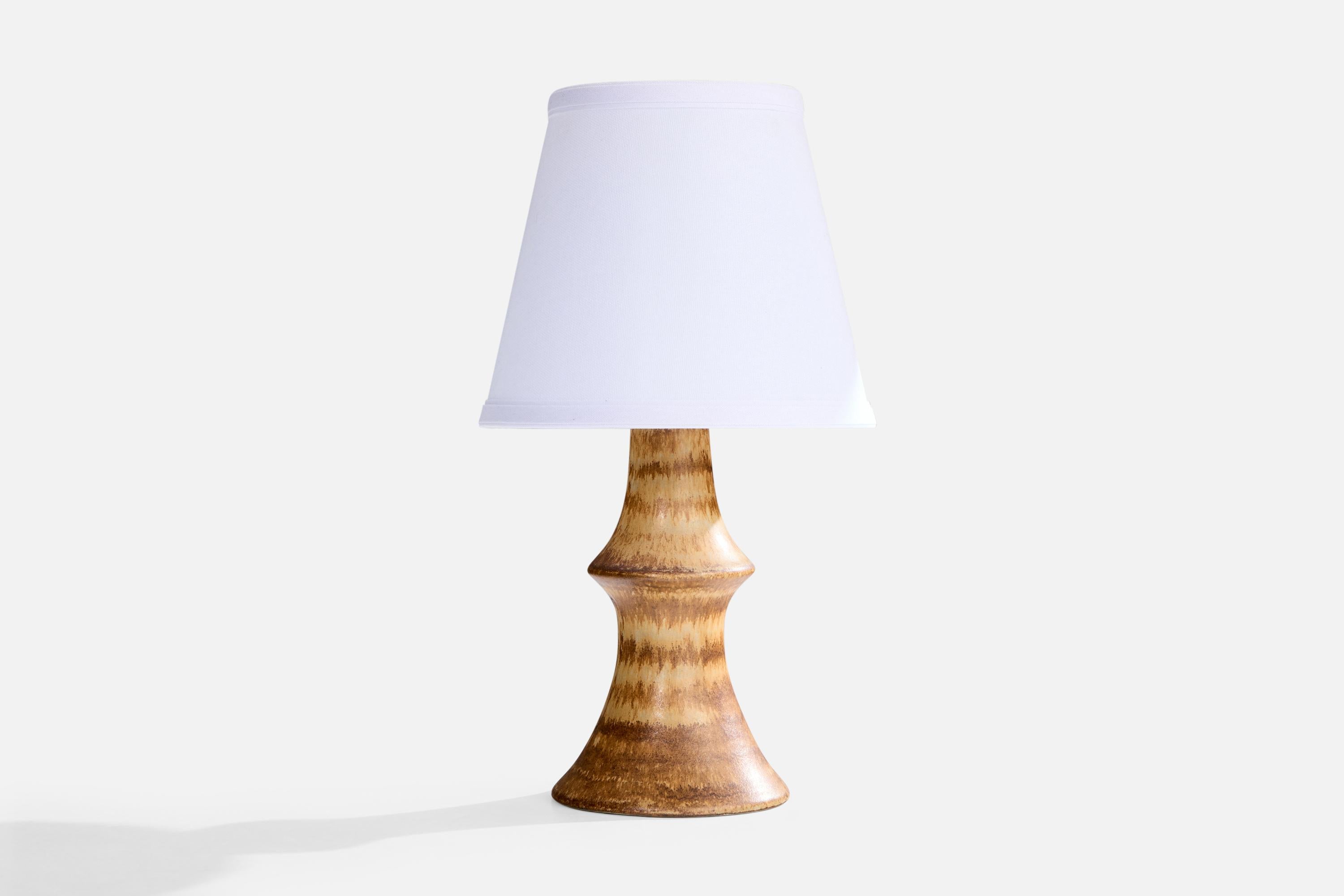 A brown and beige-glazed stoneware table lamp designed by Bruno Karlsson and produced by Ego Stengods, Sweden, c. 1960s.

Dimensions of Lamp (inches): 10.75