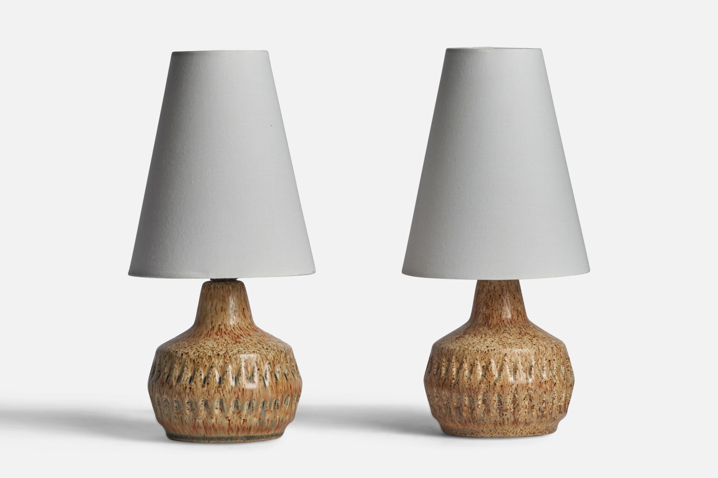 A pair of beige-glazed stoneware table lamps designed by Bruno Karlsson and produced by Ego Stengods, Sweden, c. 1960s.

Dimensions of Lamp (inches): 7” H x 4.75” Diameter
Dimensions of Shade (inches): 2.75” Top Diameter x 5.5” Bottom Diameter x