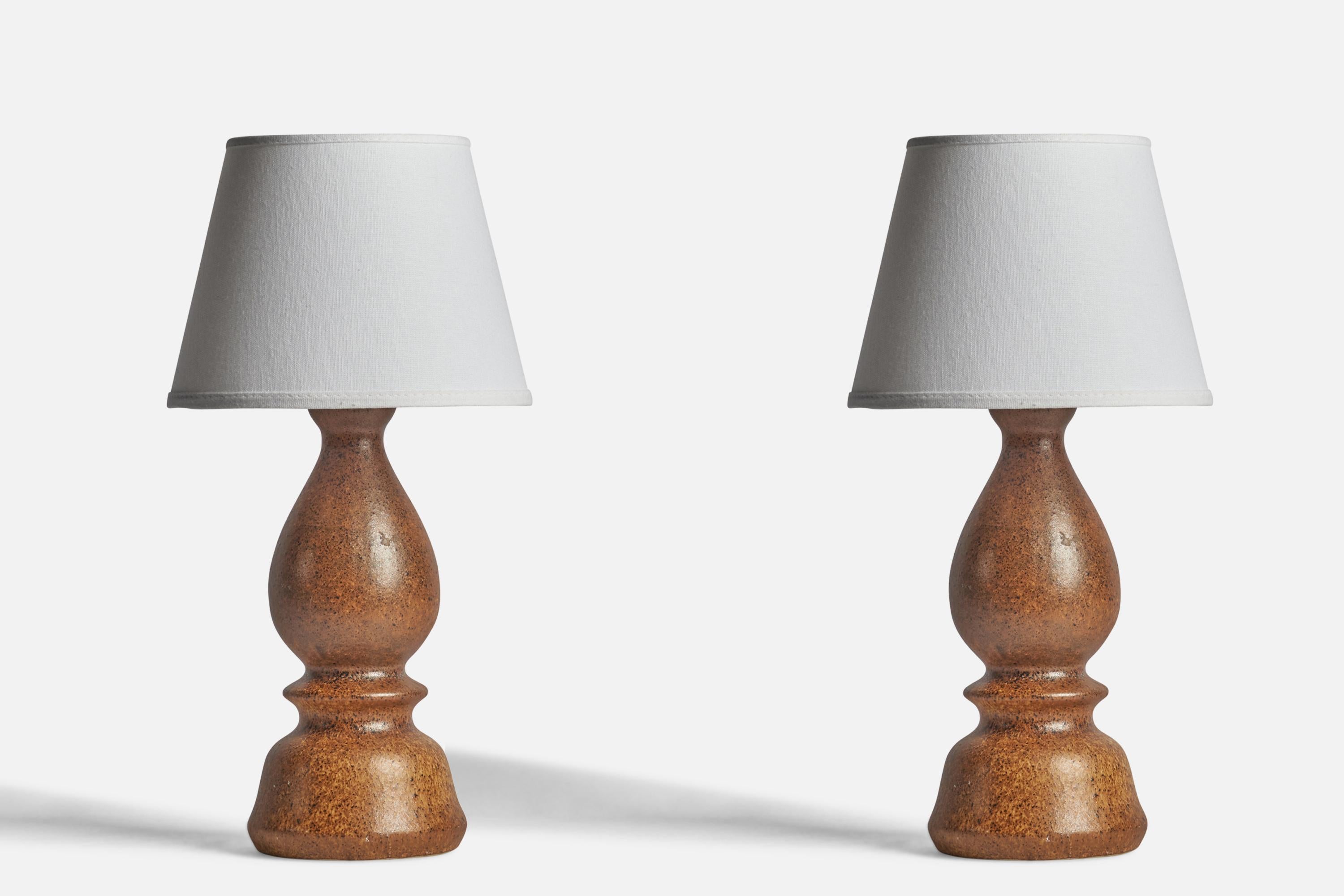 A pair of brown-glazed stoneware table lamps designed by Bruno Karlsson and produced by Ego Stengods, Sweden, 1960s.

Dimensions of Lamp (inches): 13” H x 5” Diameter
Dimensions of Shade (inches): 5” Top Diameter x 8” Bottom Diameter x 6”