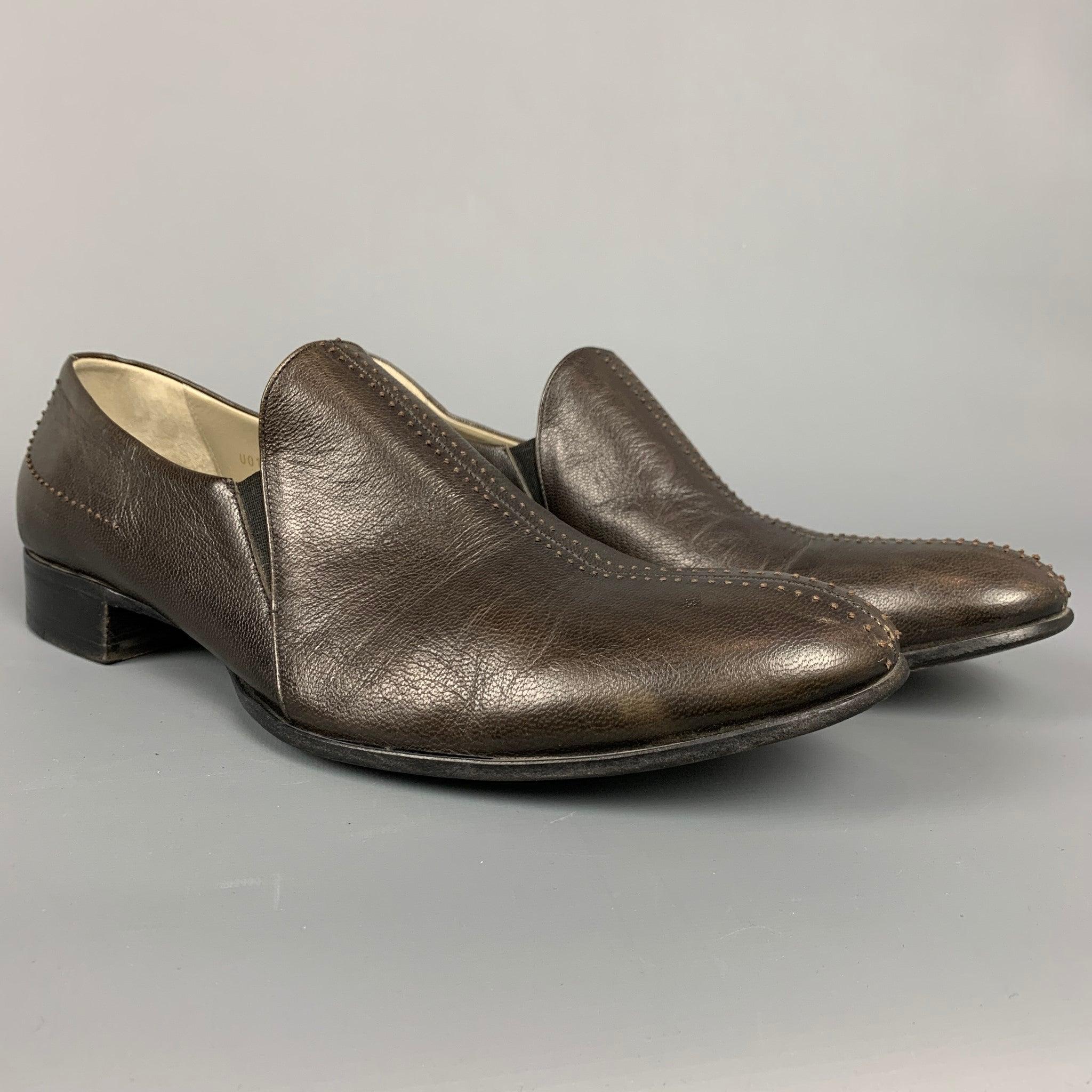 BRUNO MAGLI loafers comes in a brown leather with contrast stitching featuring a slip on style and a wooden sole. Made in Italy.Very Good
Pre-Owned Condition. 

Marked:   9 FOutsole: 4 inches  x 12.5 inches 
  
  
 
Reference: 108931
Category:
