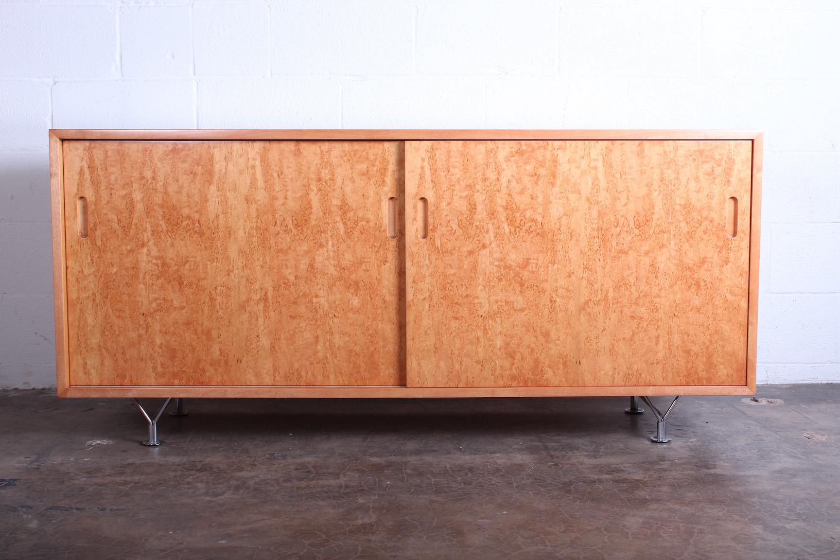 A birch sliding door cabinet designed by Bruno Mathsson.