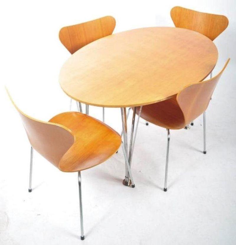 A Svenska dining table of oval/ellipse form with chromium plated multi-tubular steel tapering legs ending in chrome capped feet. Solid cherry top of substantial thickness with chamfered edge. Original label to underside 