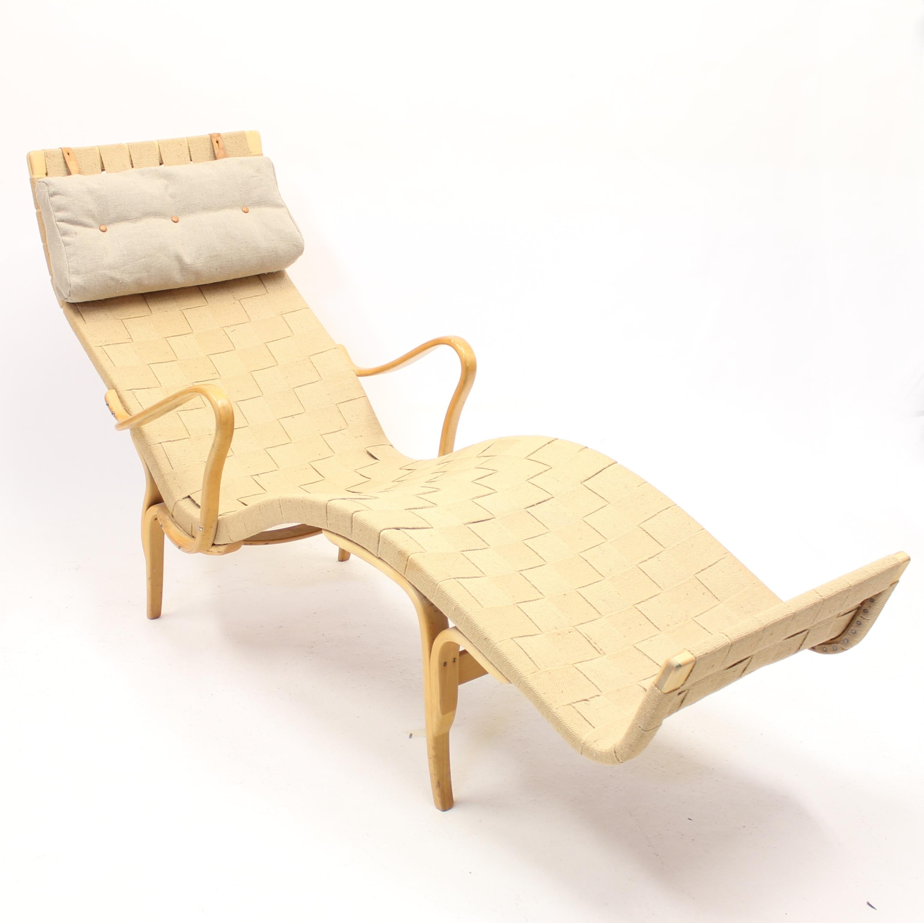 Early example of the legendary Pernilla 3 chaise lounge by Bruno Mathsson for Karl Mathsson. Designed in 1944 but this example is produced in 1959. Stamped by maker with the year. New fabric on the cushion. The webbing is most likely of a later date