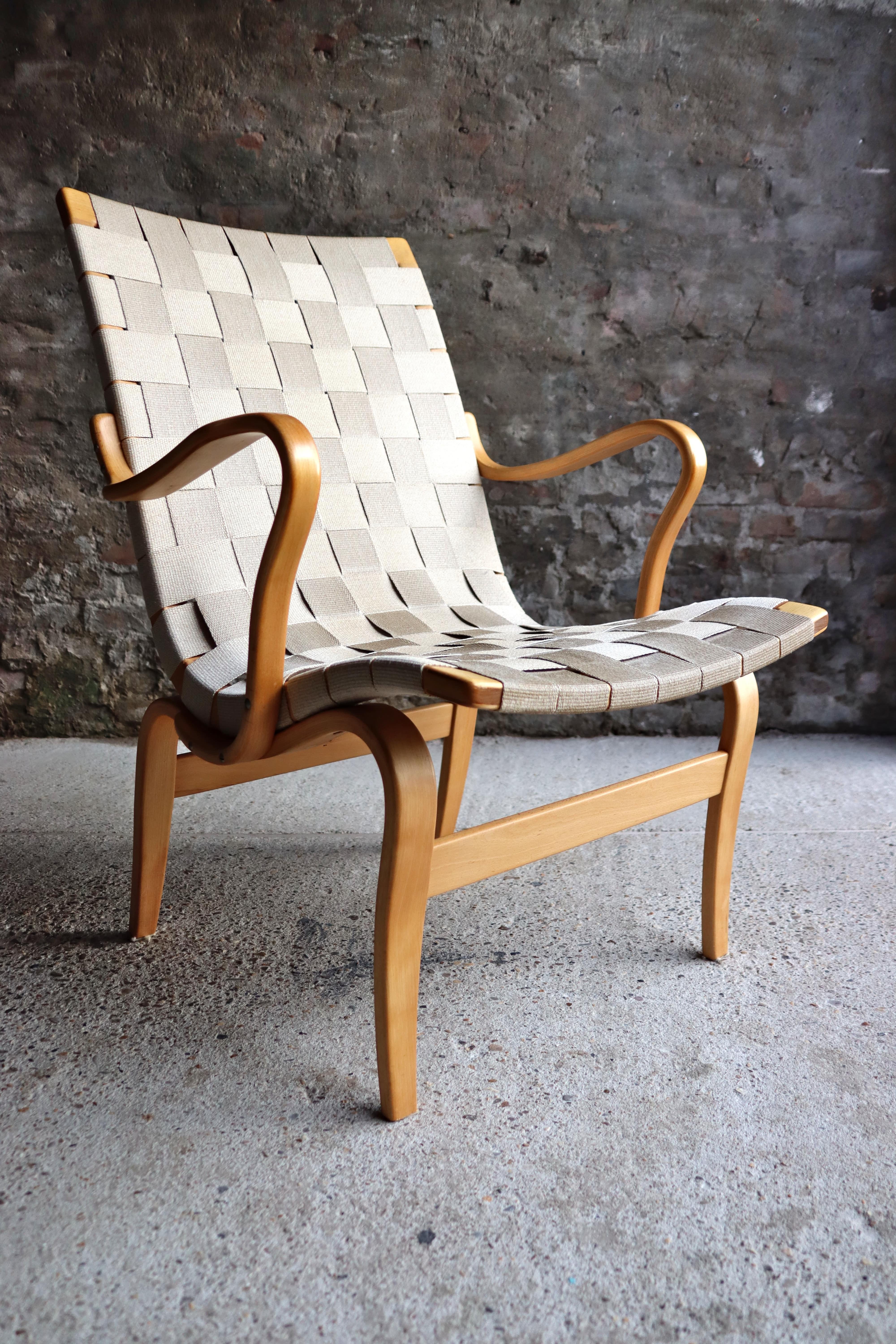 This is the Eva Chair and is designed by Bruno Mathsson for Karl Mathsson in Sweden 1960s. This one features a solid birch frame and has the original woven seat and back. Few signs of wear, overall in a very good and original condition. Signed at