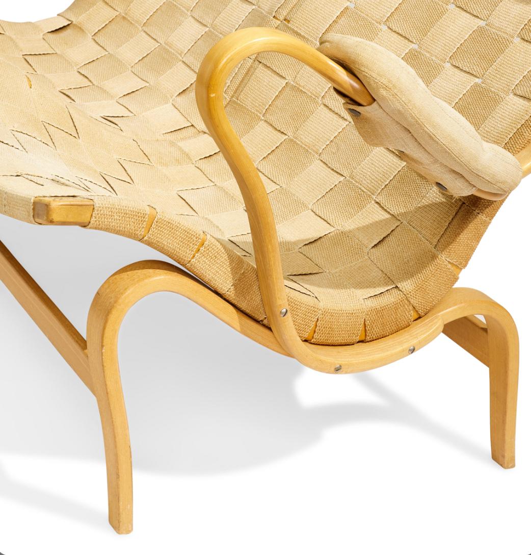 Eva Settee, designed 1935 for Firma Karl Mathsson, laminated steam-bent beech, canvas, with head and arm cushions, branded 'Bruno Mathsson Made in Sweden'.