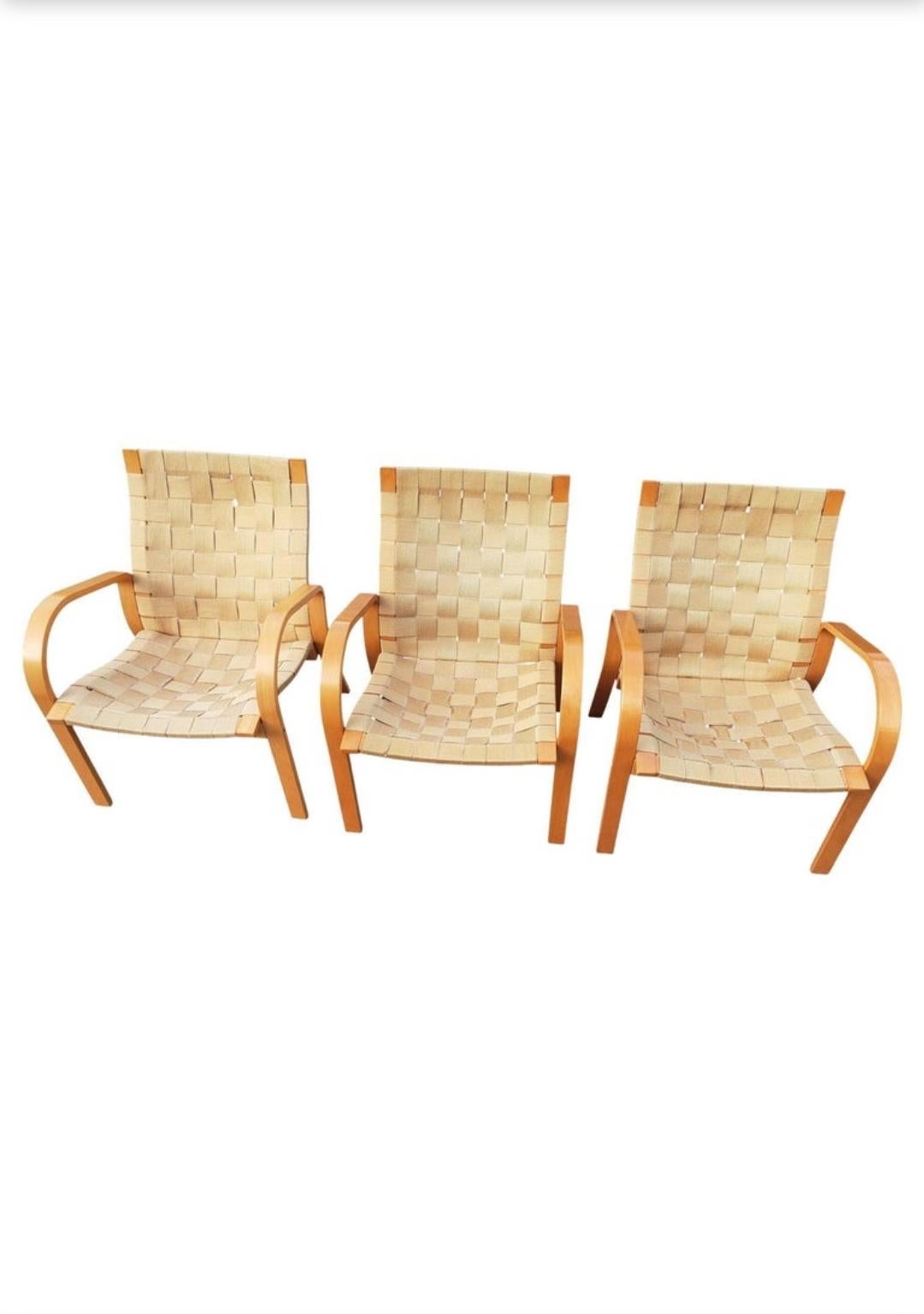 Mid Century Scandinavian Modern Beech and Canvas webbed lounge chair attributed to Bruno Mathsson.
Three 1970s lacquered beech wood chairs with gold woven canvas webbed strapping. Beech frame in very good condition.Some of the canvas straps show