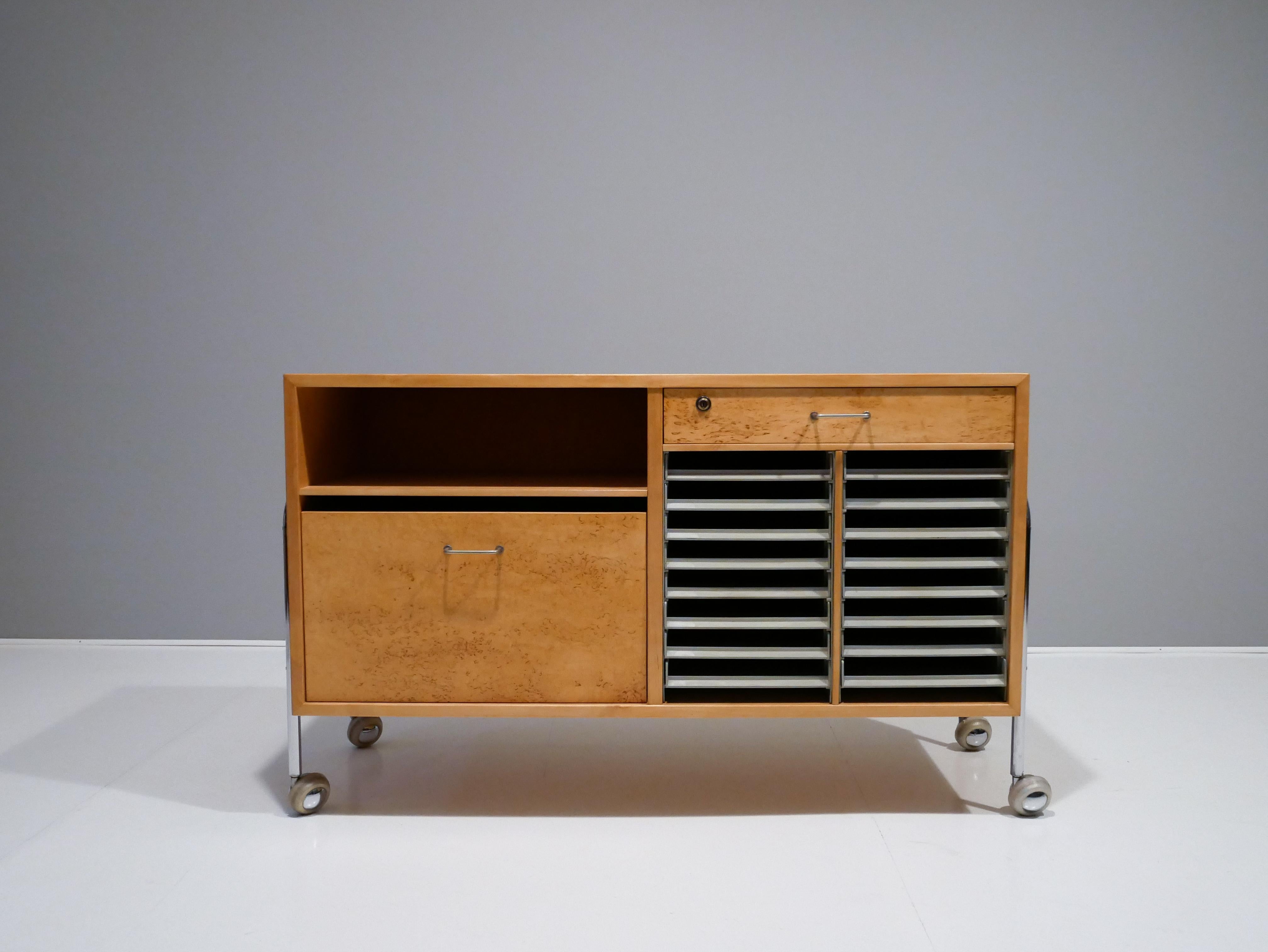 Rare sideboard designed by Bruno Mathsson and manufactured by Fritz Hansen for a very limited time. 
This freestanding sideboard are made out of the very exclusive curly birch wood.
And consists of sixteen plastic file drawers and one file