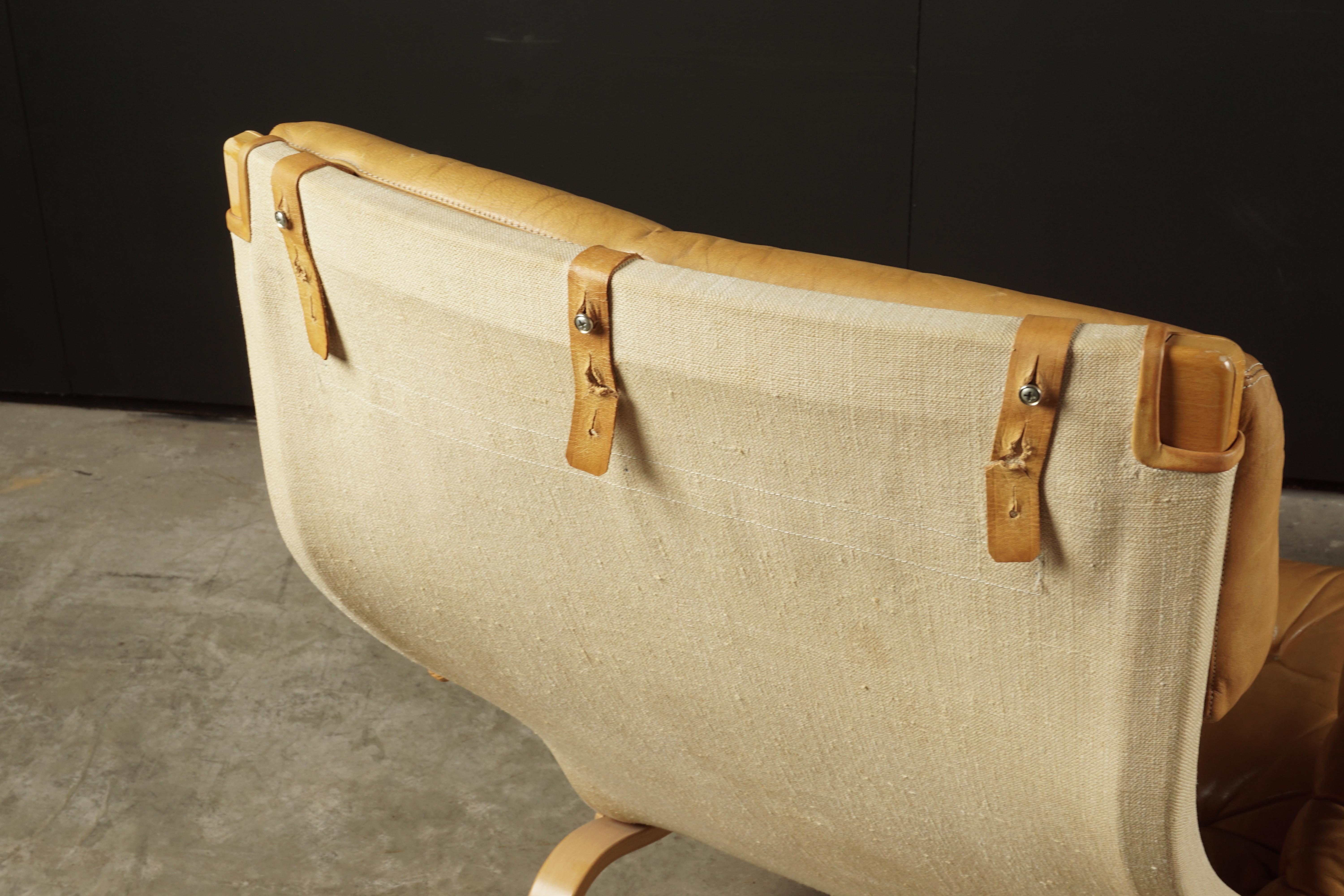 Vintage Bruno Mathsson lounge chair with ottoman, model Pernilla, circa 1970. Original tan leather upholstery. Extremely comfortable.