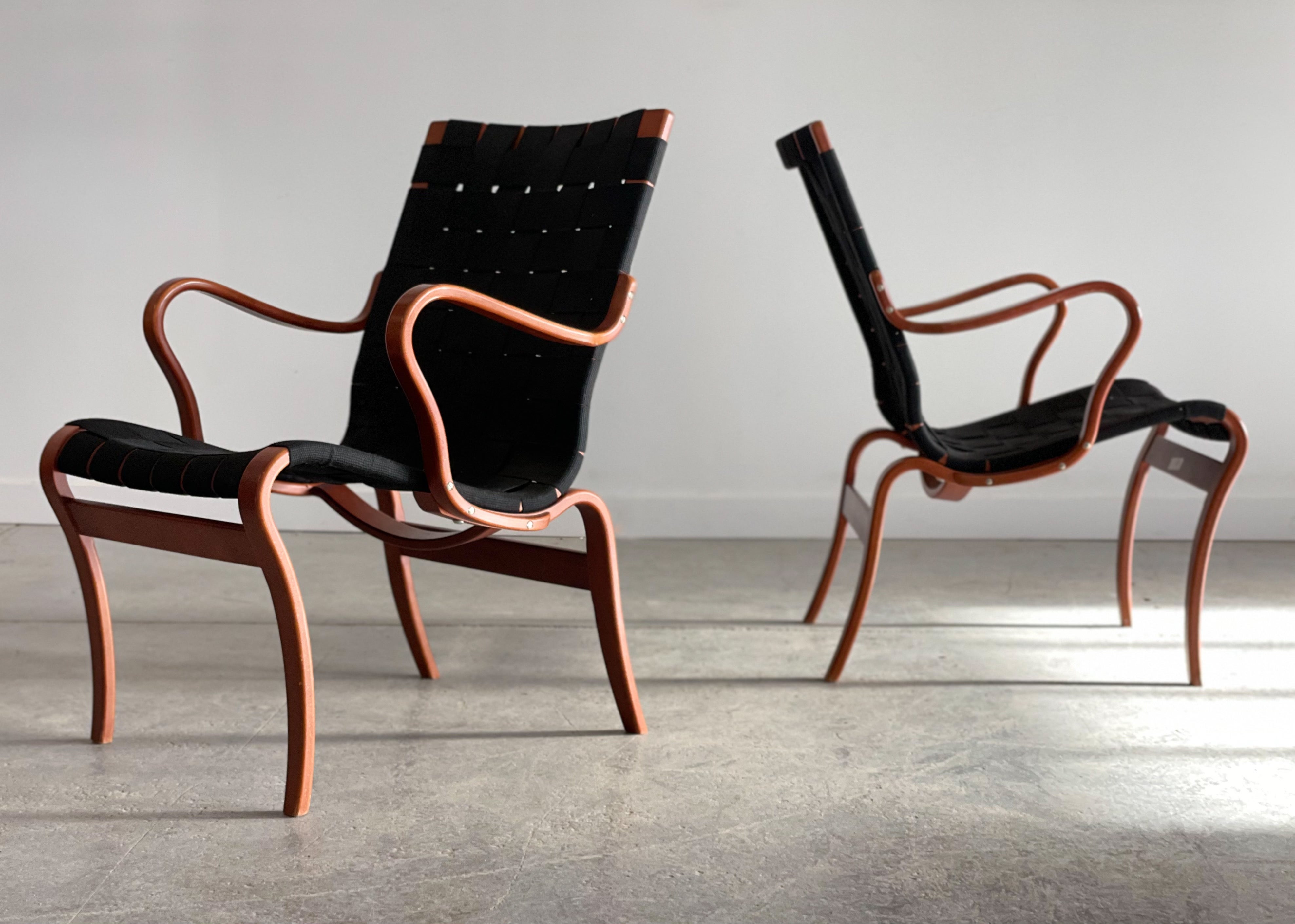 An incredible pair of ‘Mina’ lounge chairs designed by Bruno Mathsson for Dux, Sweden. These chairs feature beautifully sculptural bentwood frames with cotton webbing and are amazing from every angle. Measures 23.25”W x 26” D x 32” H back / 16”