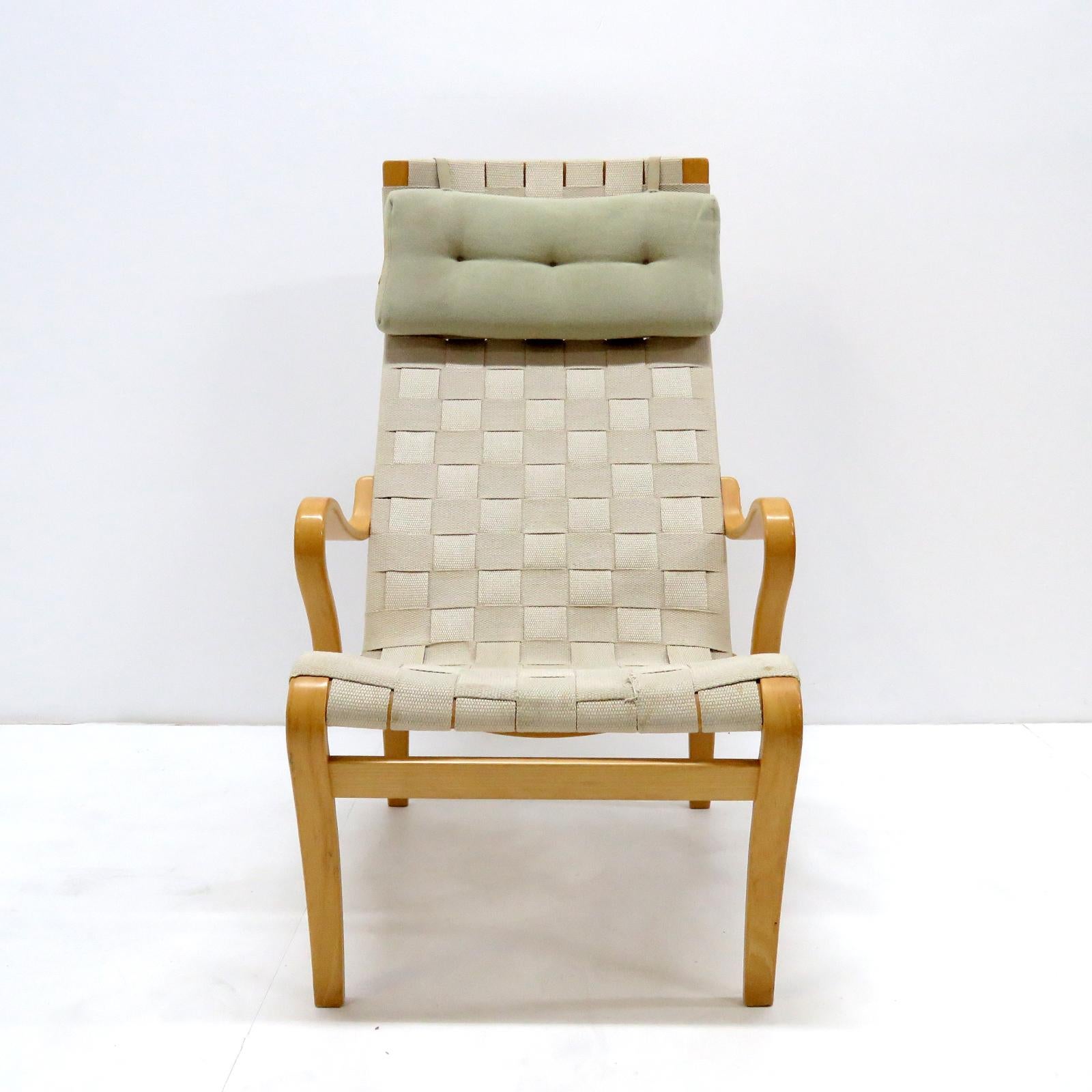 Wonderful early curvilinear lounge chair 'Miranda' by Bruno Mathsson Design Studio, composed of hemp webbing on a molded beech plywood frame with adjustable headrest on leather straps, stamped.