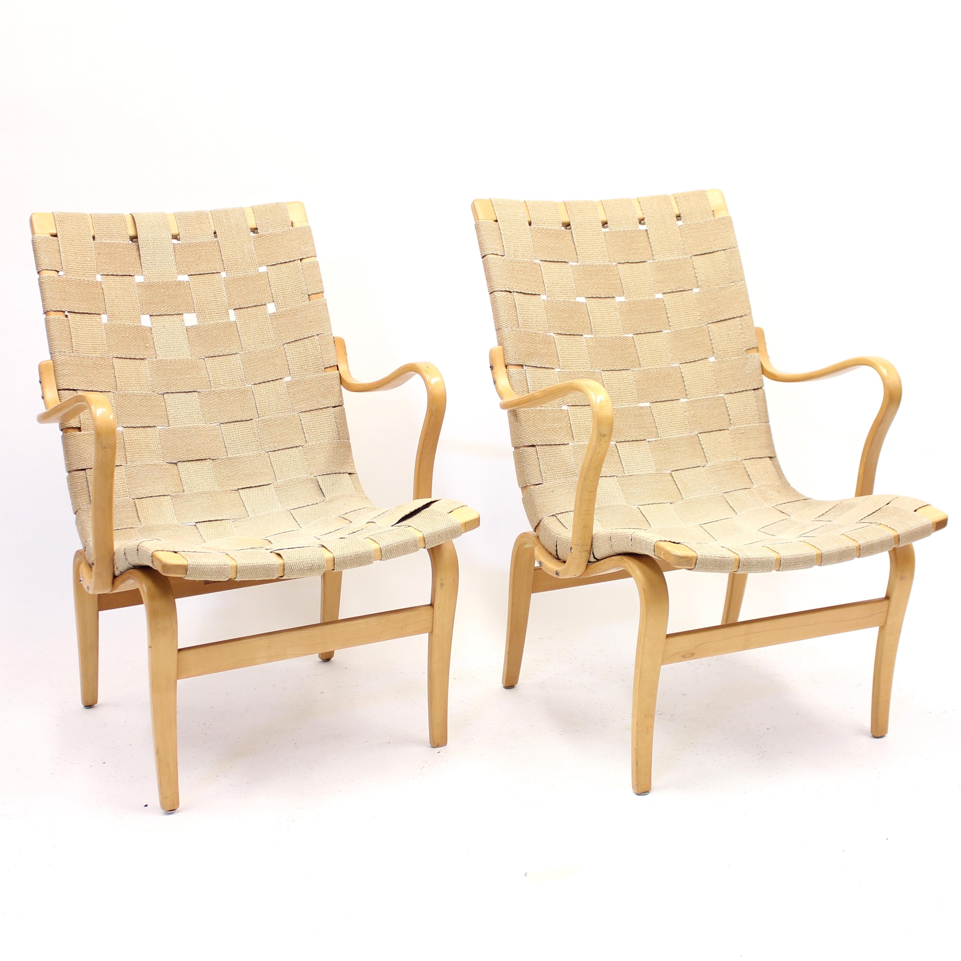 Pair of early production Eva chairs, designed by Bruno Mathsson for Karl Mathsson in 1940. This chair is also called model 41. These examples are from the 1950s. Both are stamped by maker and one of them has the original paper labels that can only