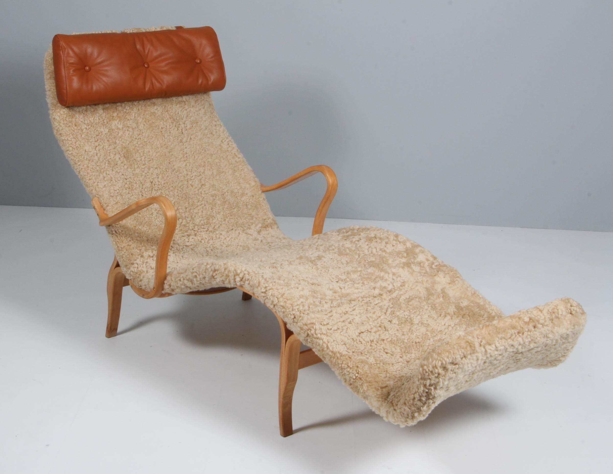 Rare lounge chair model Pernilla / T-108 by Bruno Mathsson produced by Firma Karl Mathsson Värnamo in the 1960s. The chair is in excellent condition and has been fully restored and got a new leather neck pillo and sheepskin. Chair is stamped 