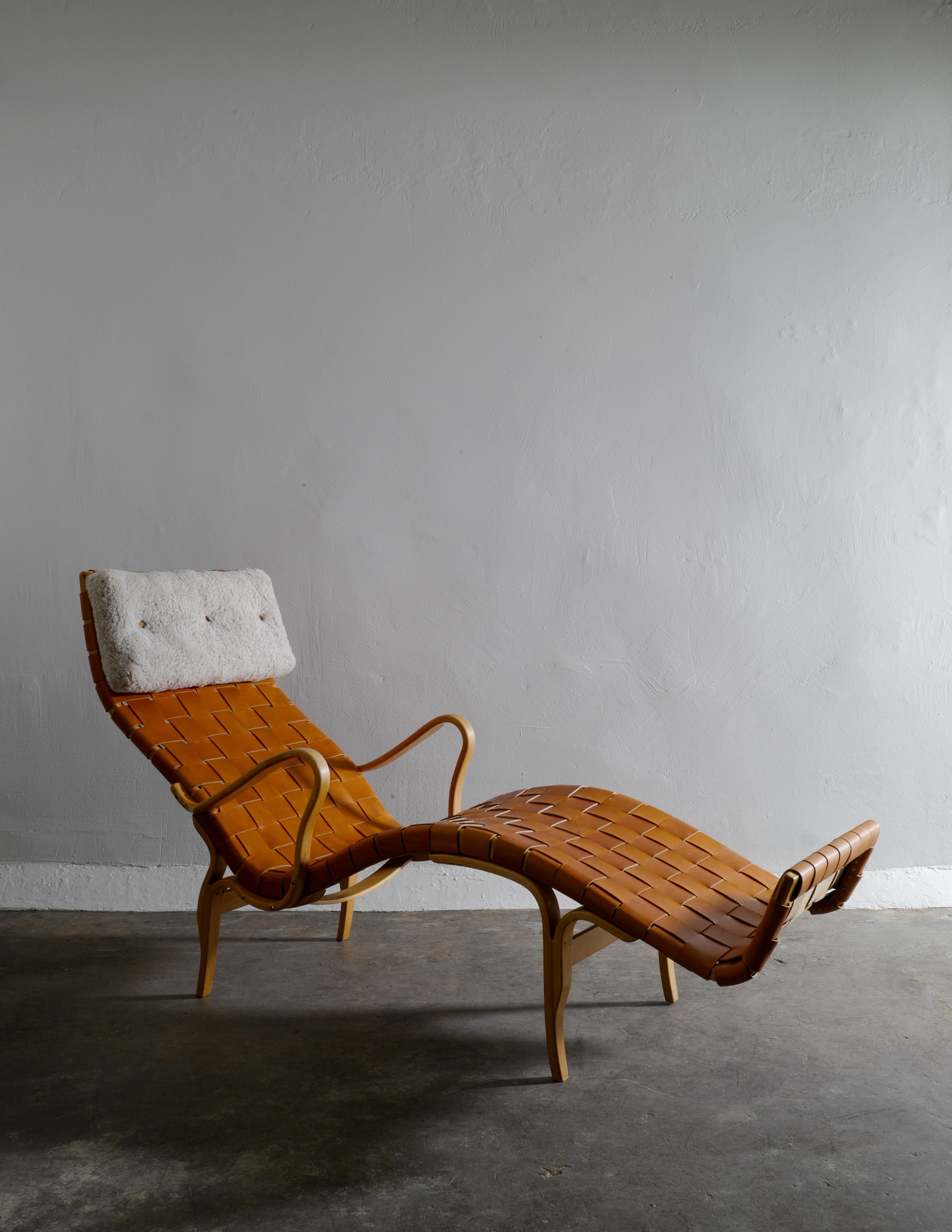 Rare lounge chair model Pernilla / T-108 by Bruno Mathsson produced by Firma Karl Mathsson Värnamo in the 1960s. The chair is in excellent condition and has been fully restored and got a newer leather seating and sheepskin neck pillow. Chair is