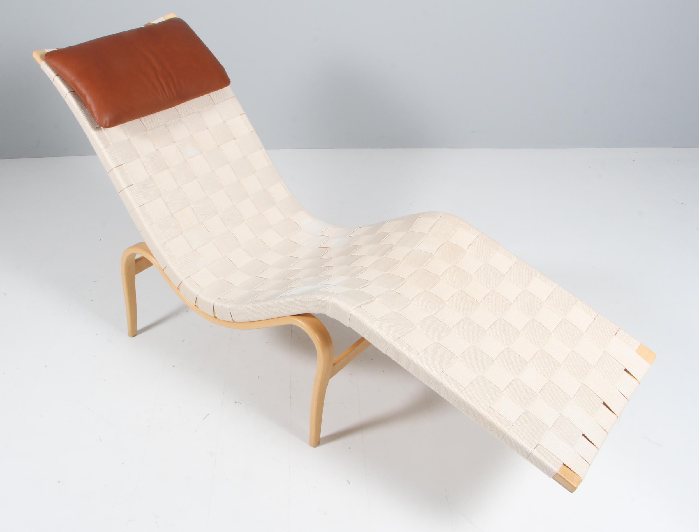 Rare lounge chair model Pernilla / T-108 by Bruno Mathsson produced by Dux. The chair is with webbing and new tan aniline leather pillow.