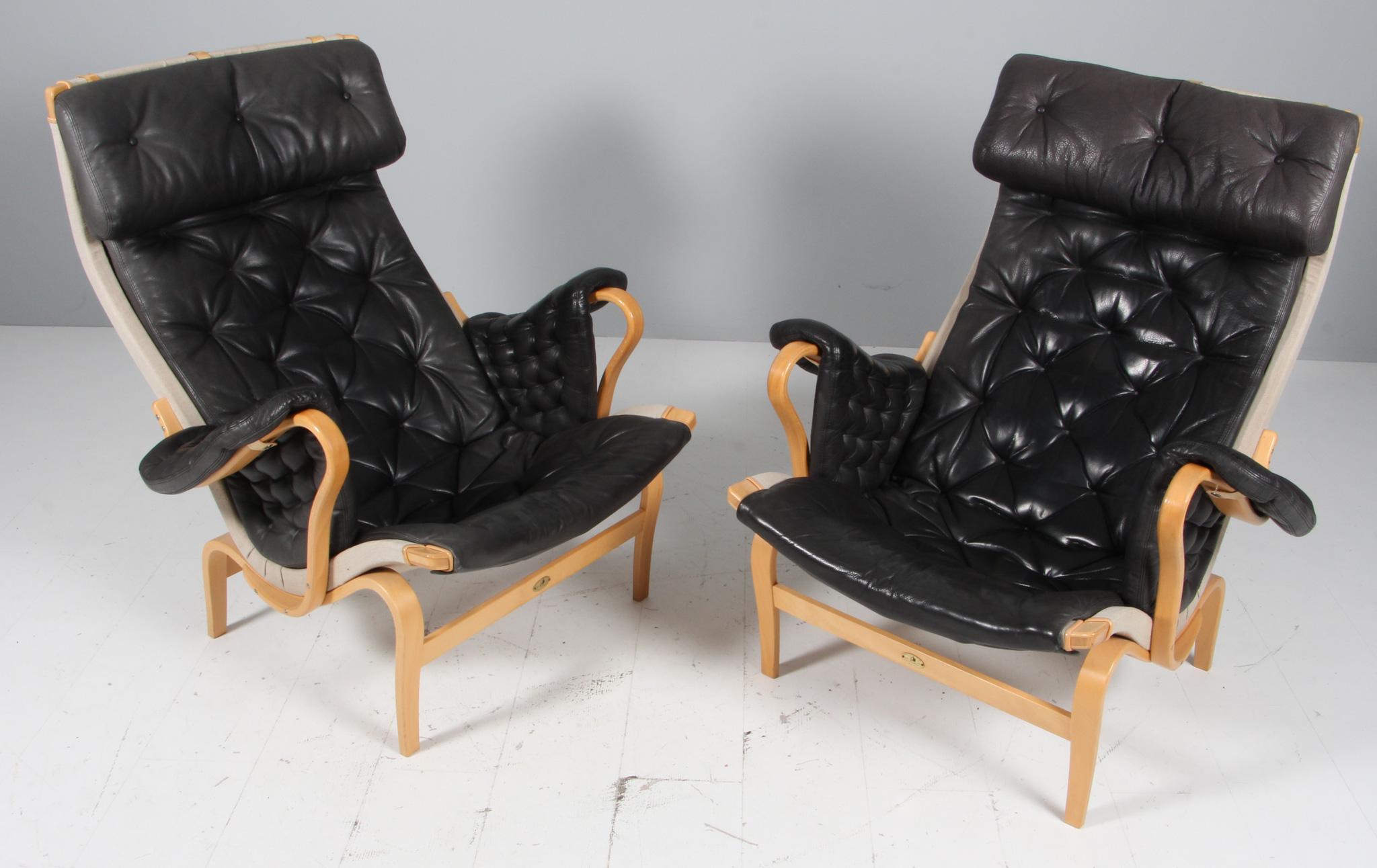 Bruno Mathsson Pernilla lounge chair with patinated black leather.

Frame in beech.

Made by DUX. 25 years annivesary model