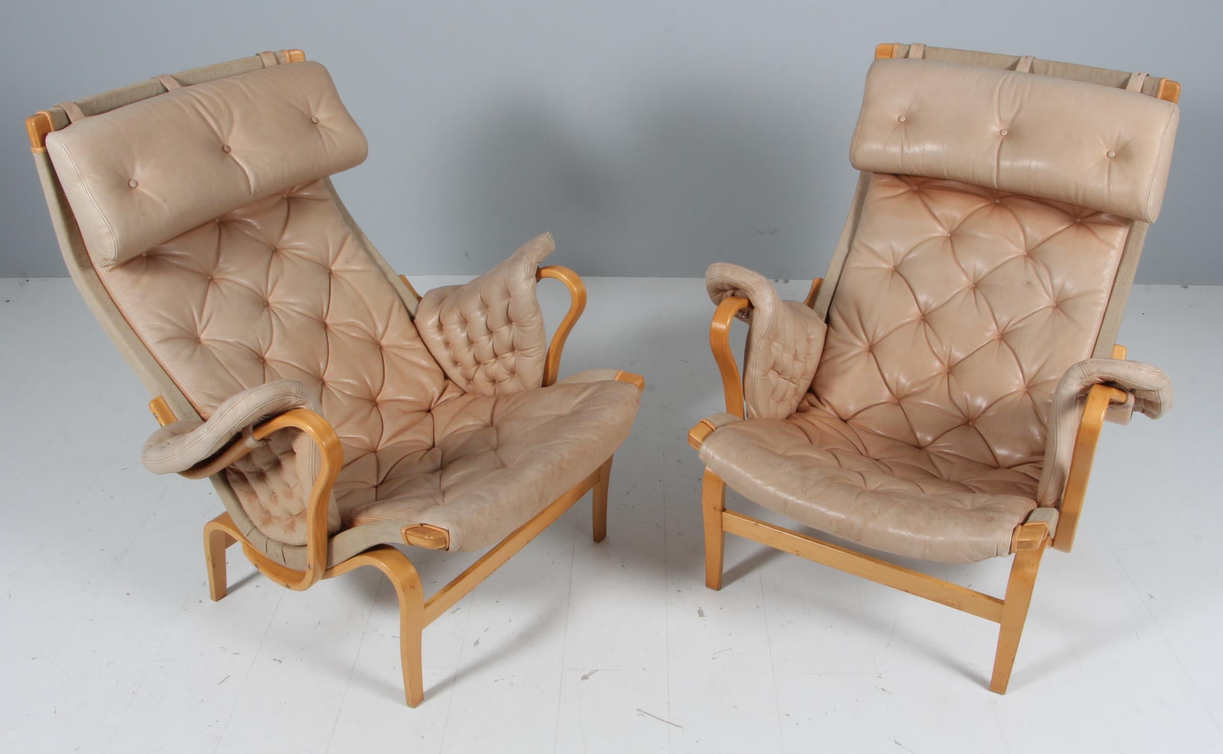 Bruno Mathsson Pernilla lounge chair with patinated tan leather.

Frame in beech.

Made by DUX.