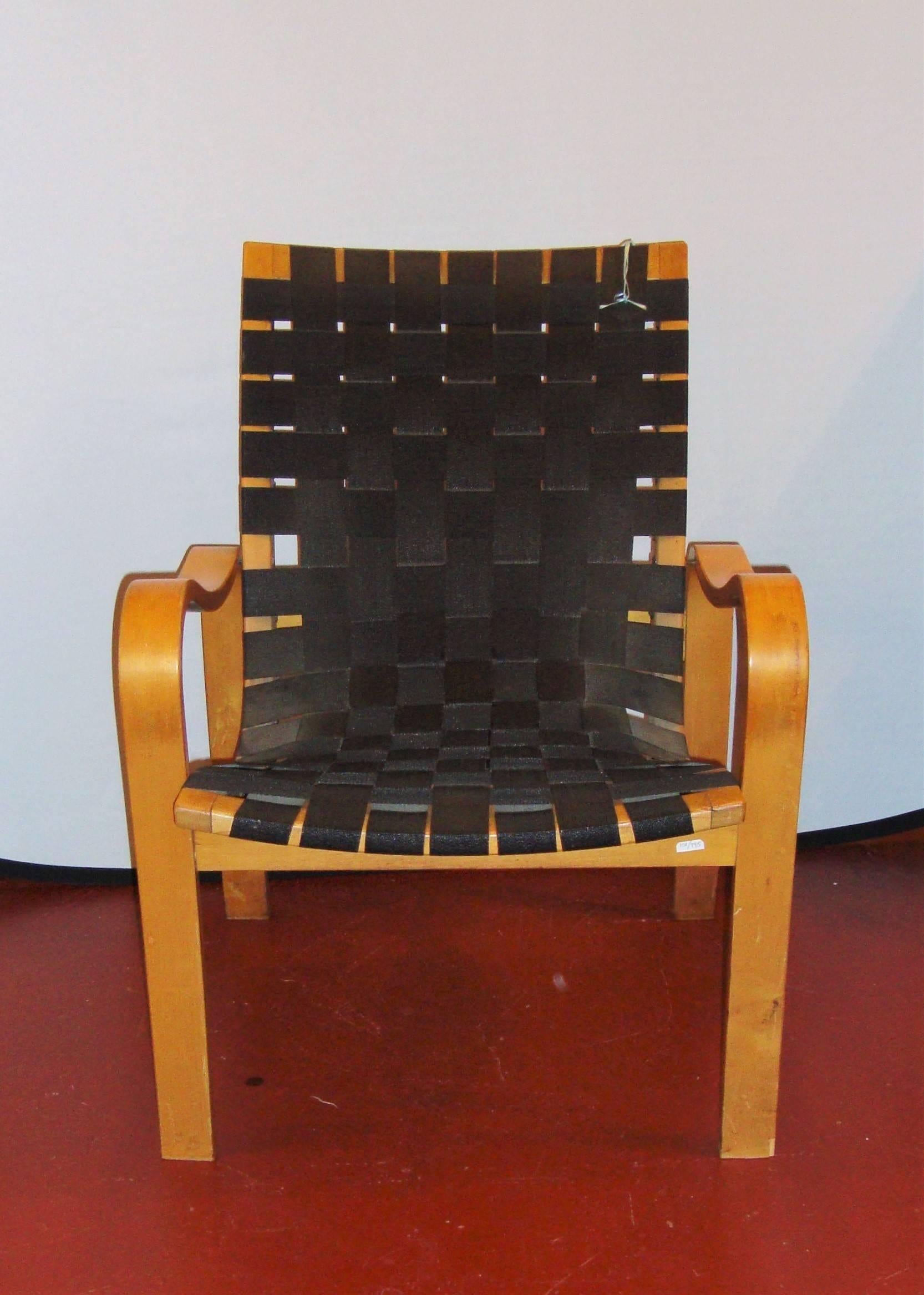 A bentwood armchair recliner with black lattice, webbed seat support. Possibly by Bruno Mathsson.

 