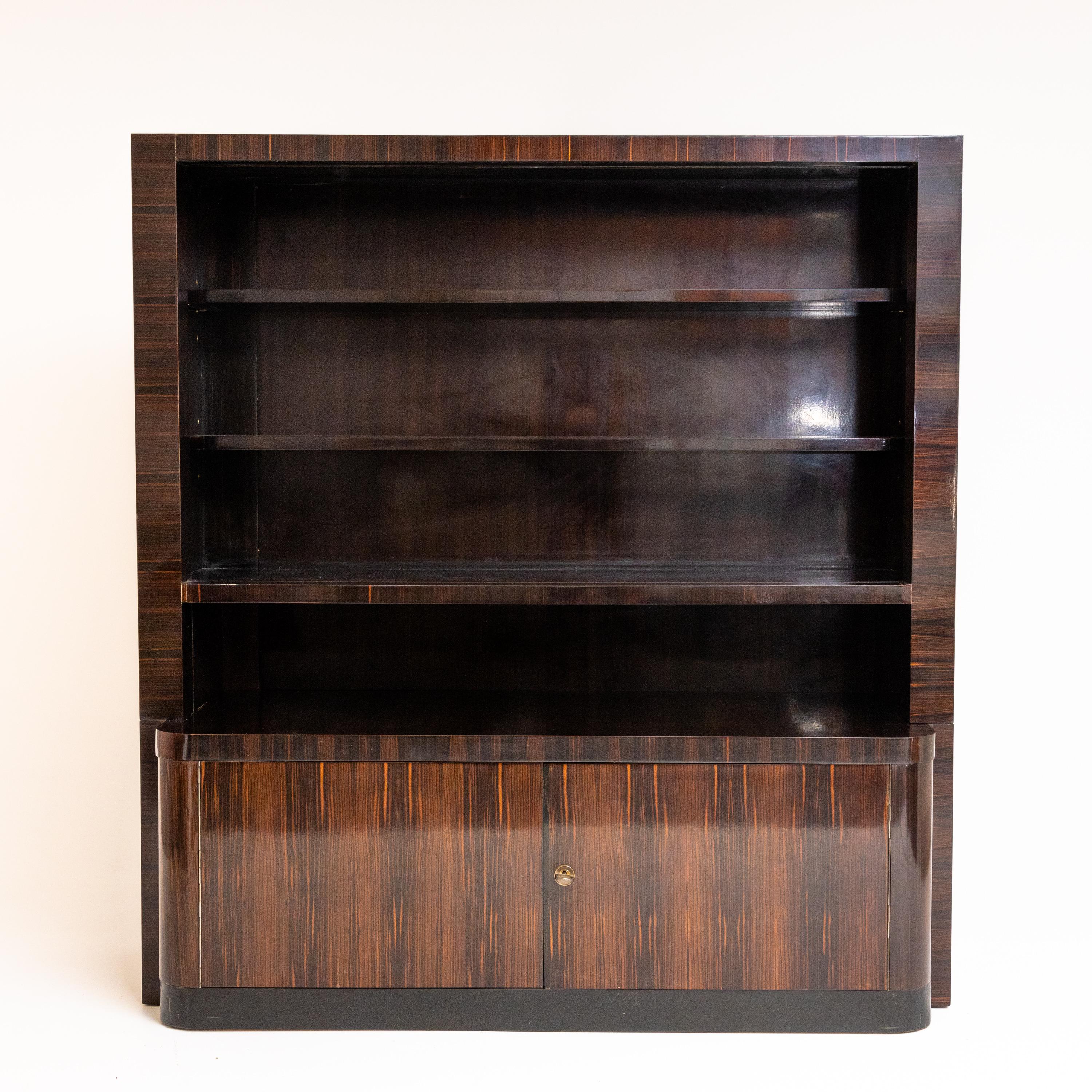 Bookcase by Bruno Paul (1874-1968) with four shelves and a two-door base cabinet. Unrestored condition.
