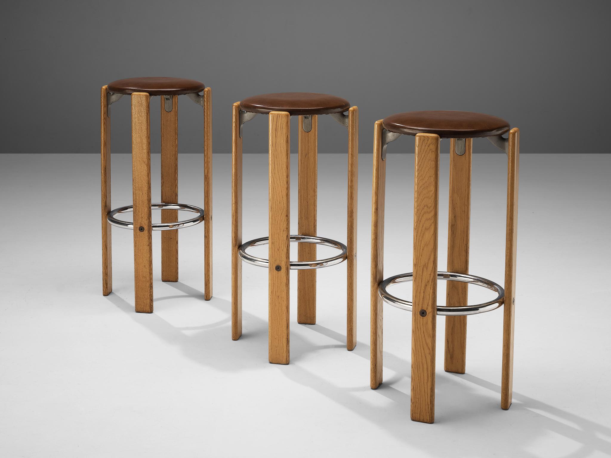 Bruno Rey for dietiker, set of 3 bar stools, birch, leatherette and metal, Switzerland, 1970s.

This set of three functionalist barstools is an iconic design by Bruno Rey. Characteristic steel brackets support the leatherette upholstered round seat.