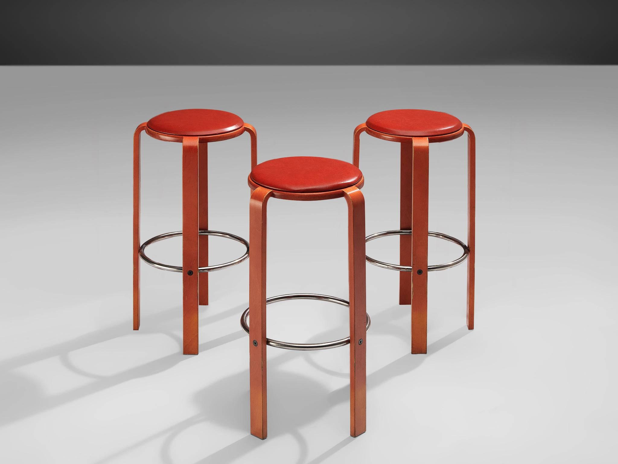 Bruno Rey for Dietiker, set of three barstools, plywood, aluminum and leather, Switzerland, 1970s

Constructed from vibrant red lacquered wood, the stools exude a sense of warmth and sophistication, while the padded seats, luxuriously finished with
