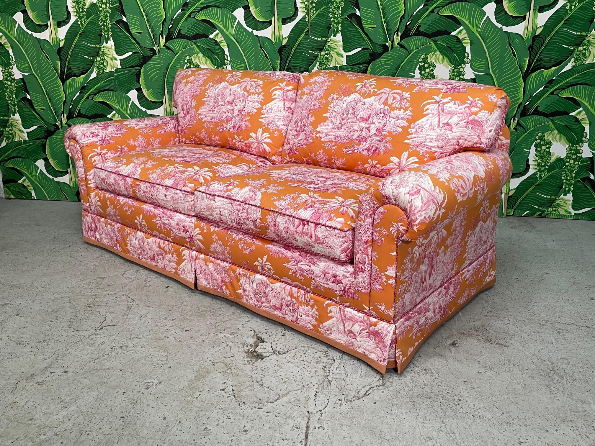 Fully upholstered sofa by Brunshwig & Fils features down filled cushions and a bright chinoiserie print. Excellent condition. We also have the matching club chairs for sale.
 