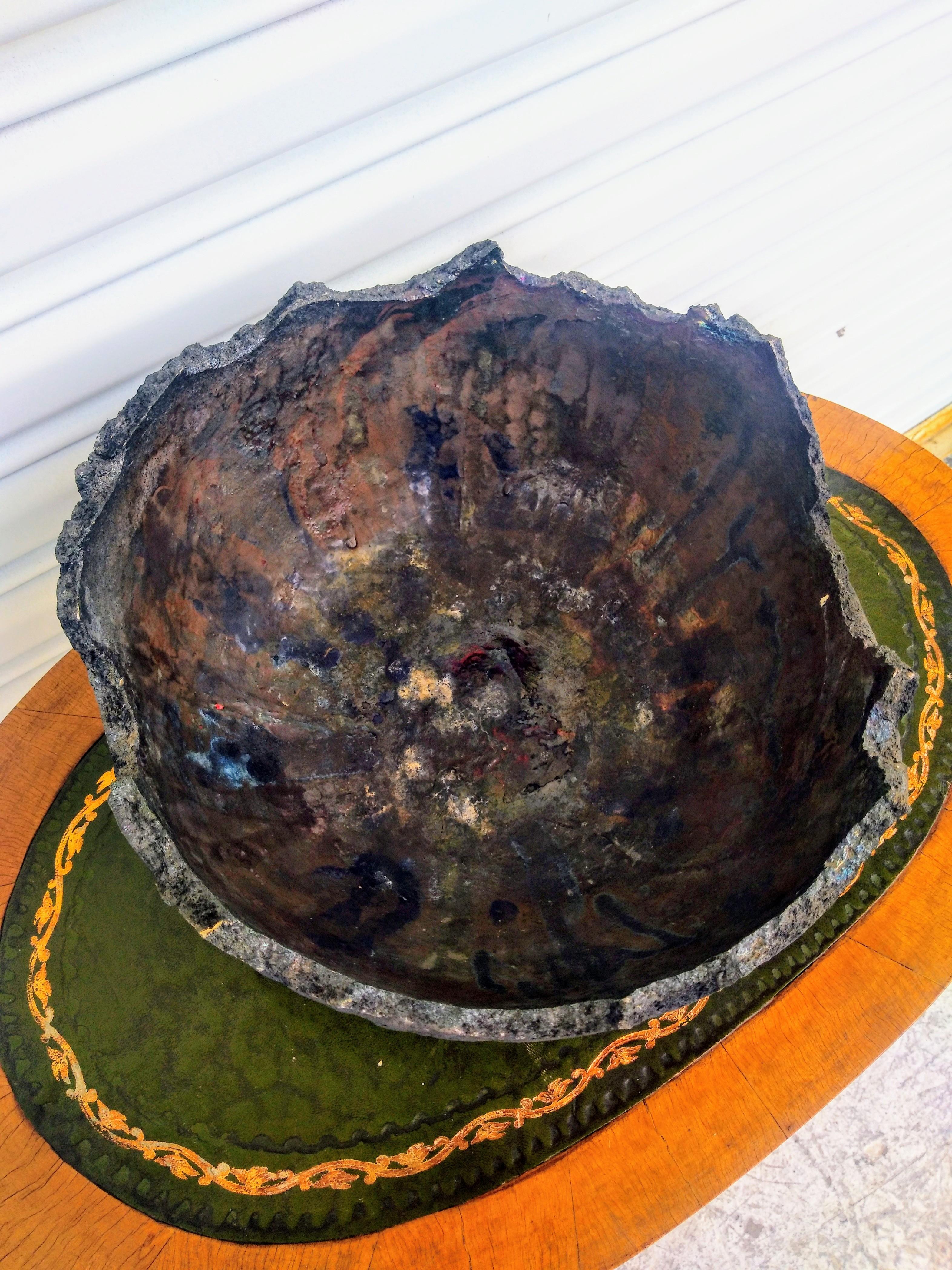 This is a beautiful ridged edge decorative bowl designed by Bruny Graves. The bowl was rendered in the traditional Raku technique called Raku. Raku is a firing process that produces unpredictable and unique results in the glaze.