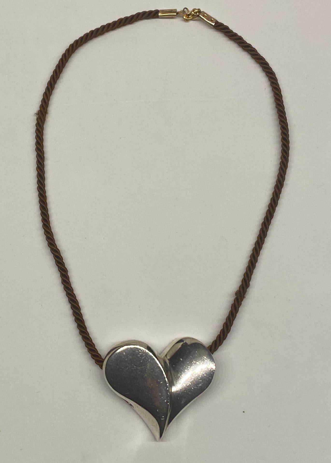 Modernist design sterling silver heart pendant by New York City jewelry design team Jack Brusca and Joseph Dante in 1975. The pendant is 2 inches wide, 1.75 inches high and .75 of an inch deep in cast sterling silver. It is shown on and included