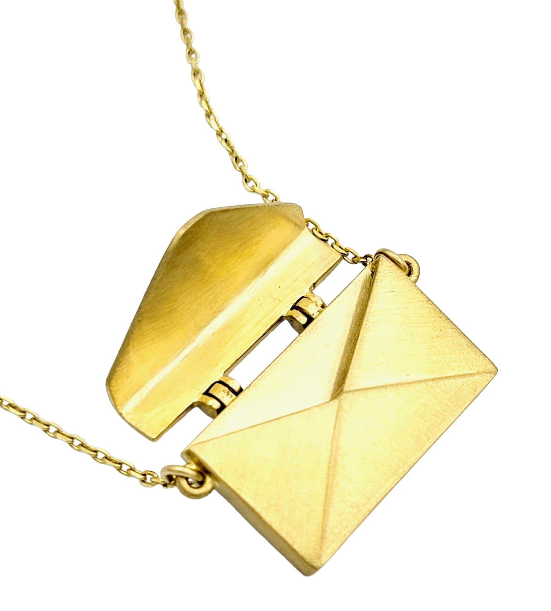 This lovely envelope pendant necklace is a timeless and understated piece of jewelry that embodies both elegance and simplicity. Crafted with precision and an eye for detail, this necklace captures the essence of sophistication.

The pendant
