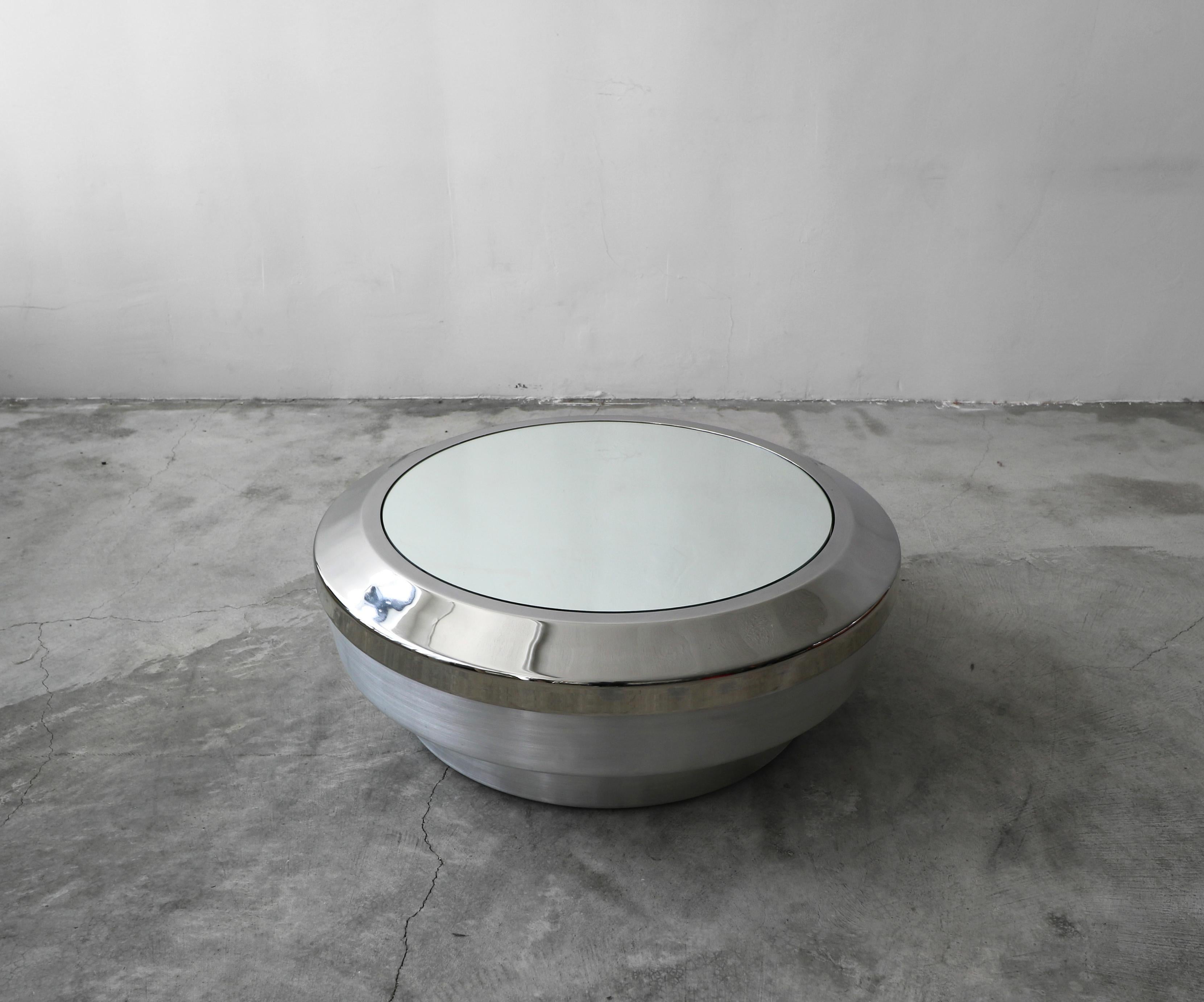 TWO AVAILABLE

Beautiful brushed aluminum, chrome and mirror drum canister coffee table by architect Gary John Neville. Top is removable to provide a great storage space for blankets, pillows, etc.

Table is in excellent condition with no real