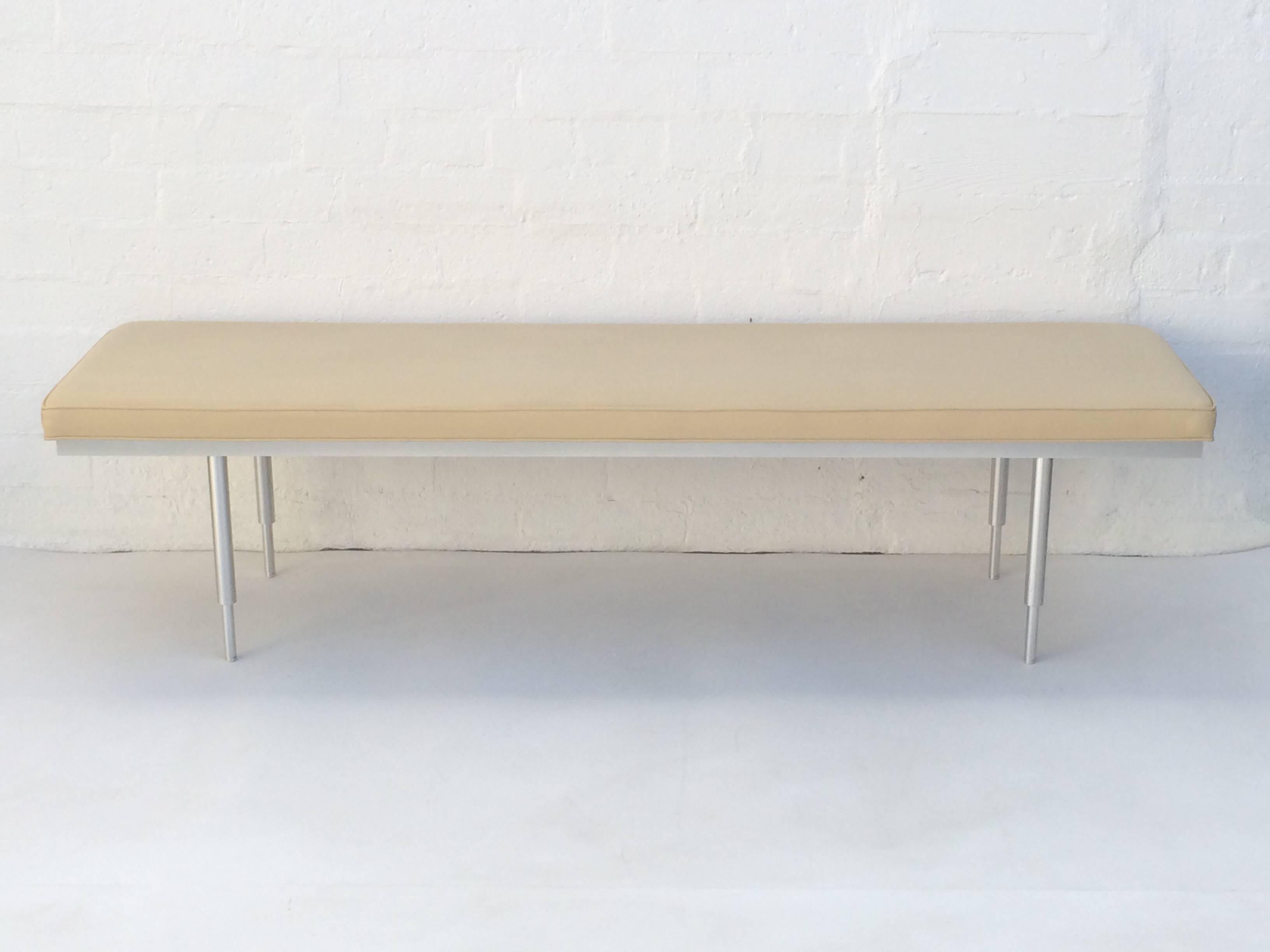 A 1980s brushed aluminum with soft leather bench.
Very well constructed.
The legs are adjustable for two different positions, they unscrew and there are screw holes that are closer together or farther away at the end.