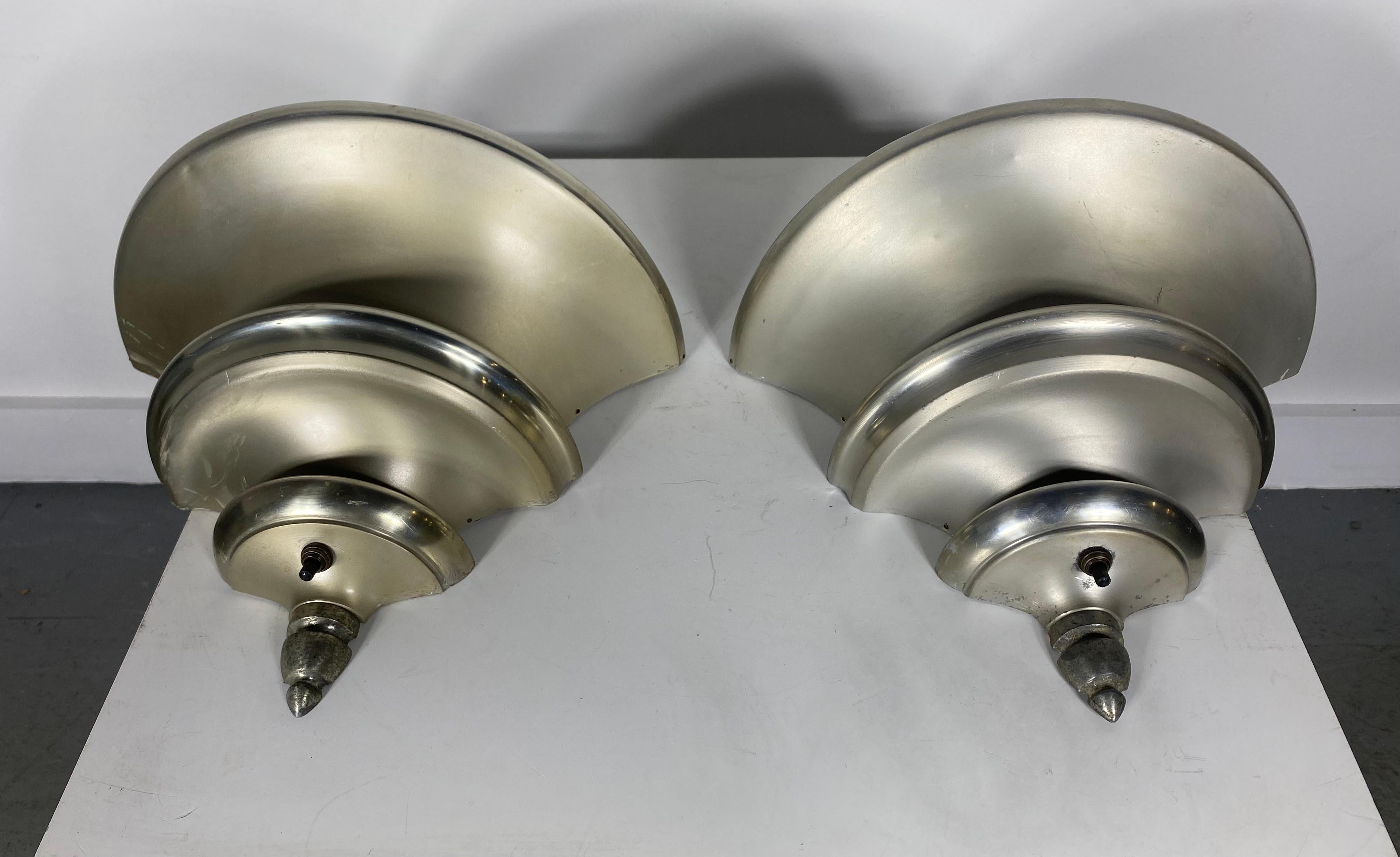 Pair of brushed aluminum Art Deco wall sconces with polished accents designed by Walter Von Nessen. circa 1930s. Classic design.