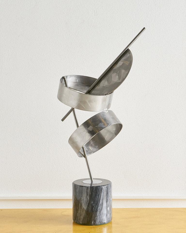 A dynamic sculpture in the manner of Curtis Jere, made from brushed aluminum and black Italian marble, fantastic height and shape, 1980s. 

  