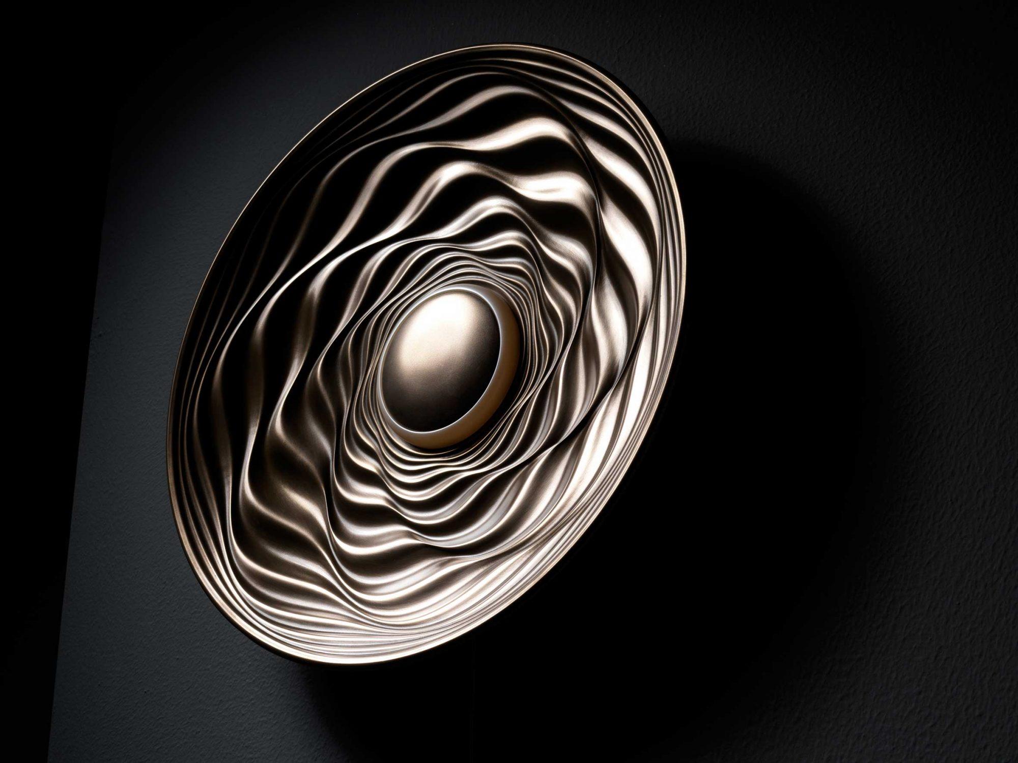 Brushed Bronze Resin Illuminated Sculpture Transmission by David Tragen
Dimensions:  W 42.5 x D 42.5 x H 8 cm
Materials: Brushed bronze resin, LED, patinated back.
Weight: 6 kg.

About: He left university with a degree in International Business in