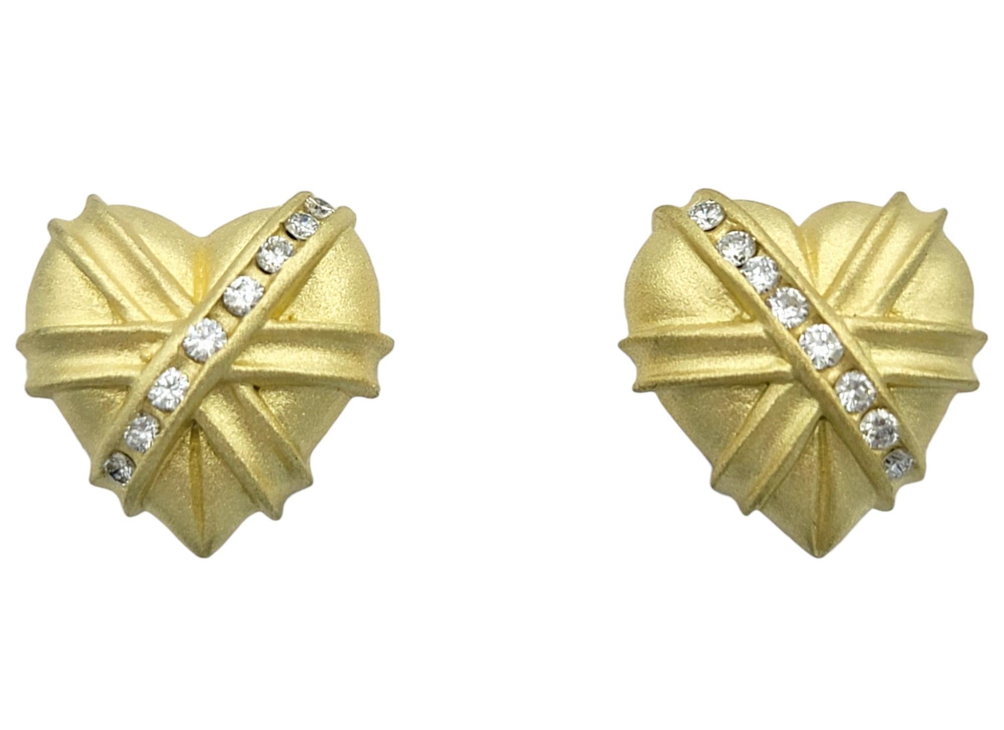 Embrace a romantic blend of elegance and whimsy with these charming textured heart stud earrings, beautifully crafted in luxurious 18 karat yellow gold. Each earring features a softly rounded, brushed-textured heart that captures the light with a