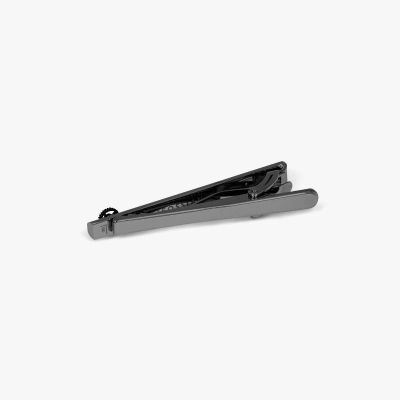 Brushed Gear Tie Clip with Gunmetal Finish

A single spinning gear, carefully mounted on the end of our highly-polished tie clip creates a fun sense of movement to add to your look. The gear and frame is set in black rhodium plated base metal for a