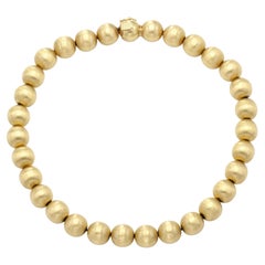 Collana di palline in oro spazzolato