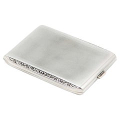 Brushed rectangular silver case with beveled corners and gold interior