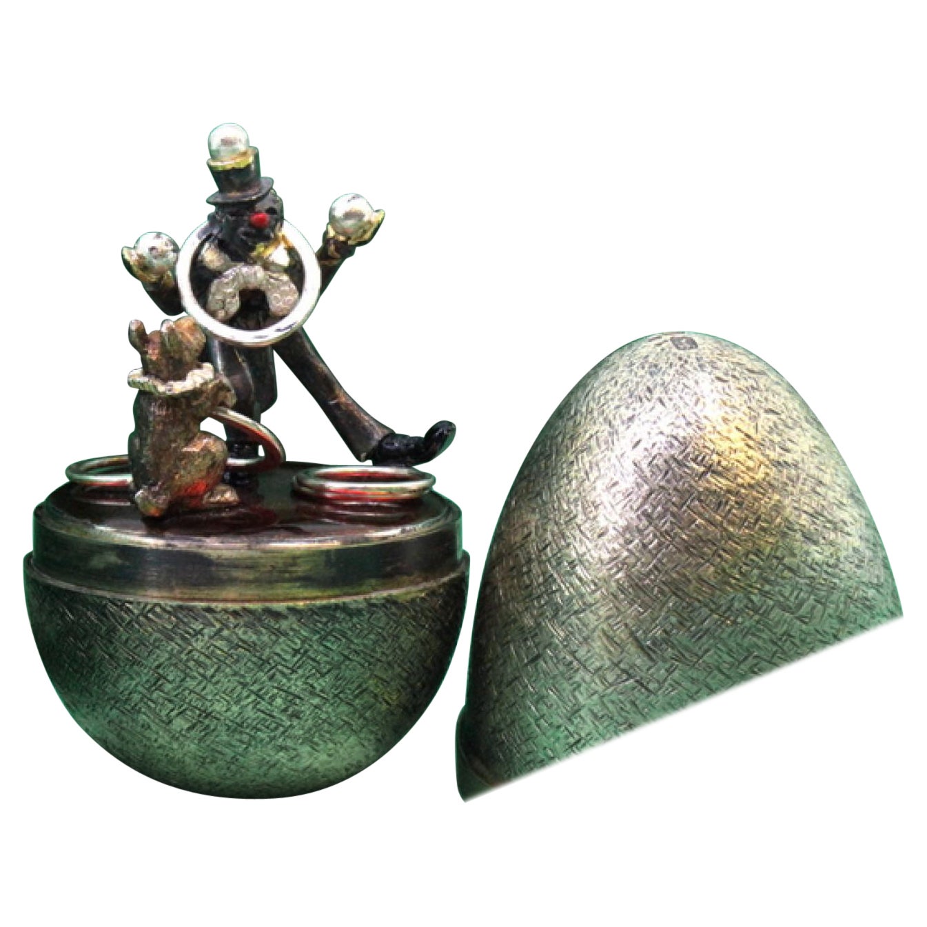 Brushed silver egg with a clown and circus dog inside, Fabergé style