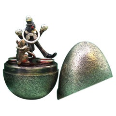 Brushed silver egg with a clown and circus dog inside, Fabergé style