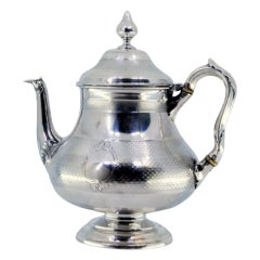 Brushed silver teapot with smooth trim on the surround and knob on the lid