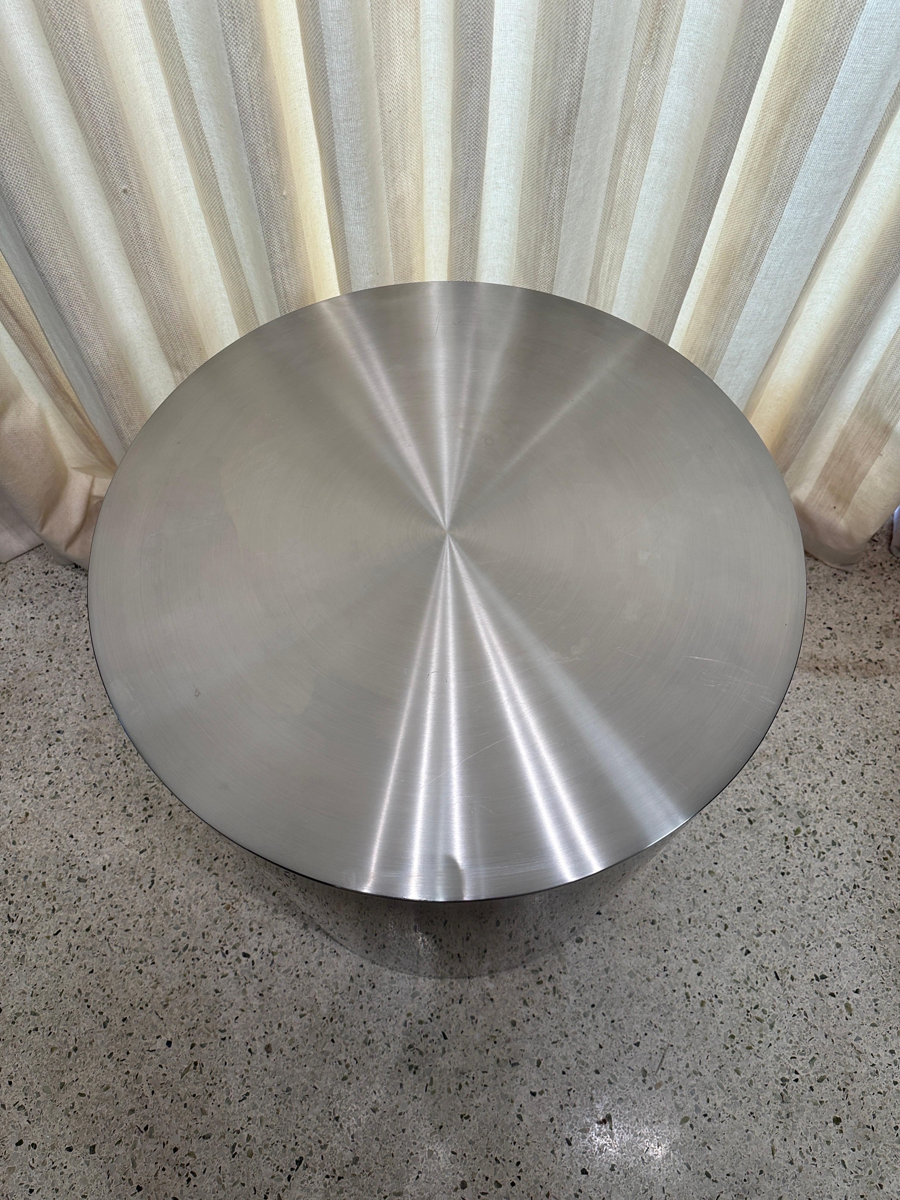This amazing brushed stainless steel column/ pedestal base which can also be used as a dining table base by adding a custom thick round glass.  The beautiful finish is modern and industrial with minimal wear to top (minor scratches).  Style of Maria