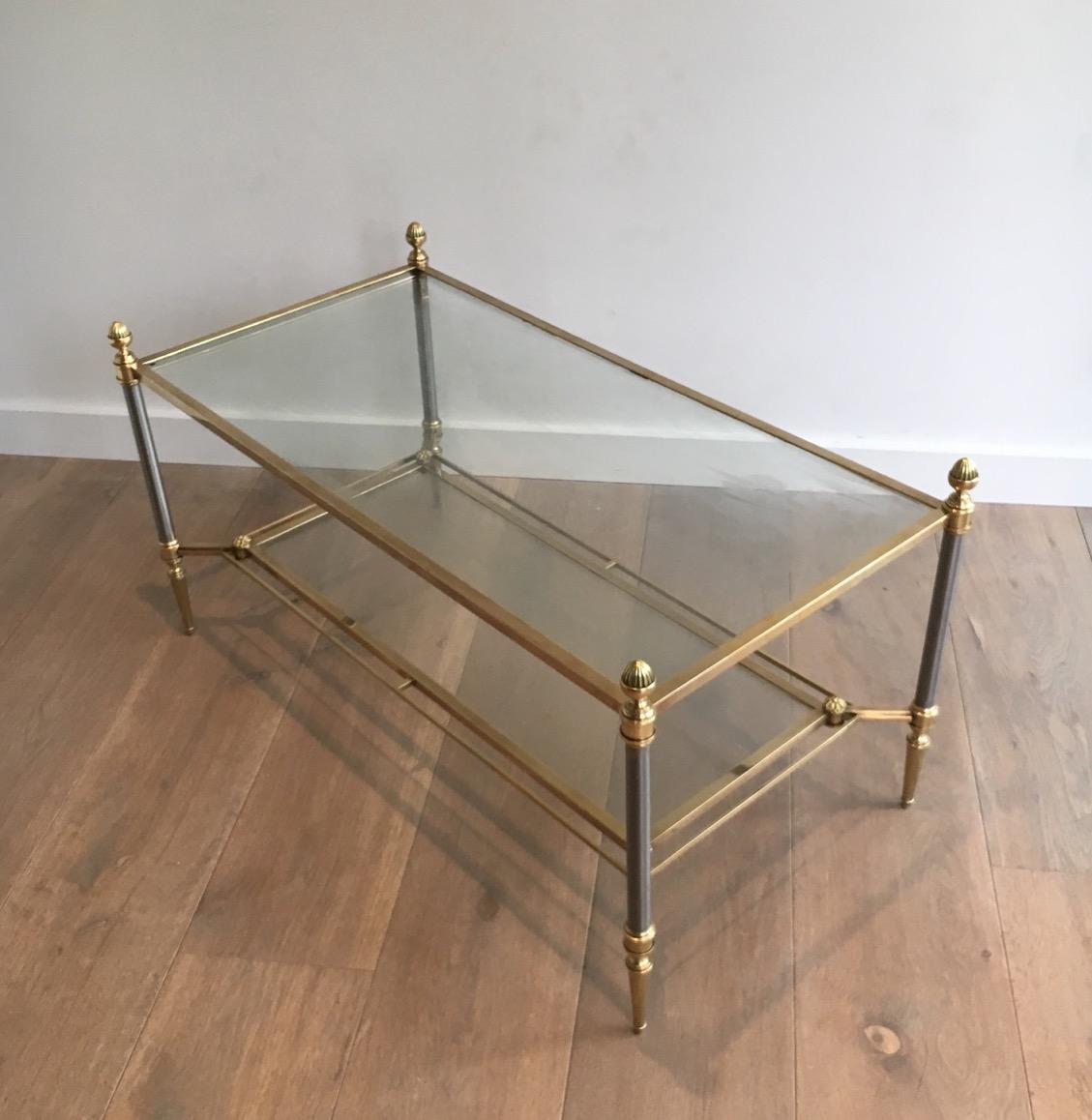 This very nice and elegant neoclassical style coffee table is made of brushed steel and brass with two glass shelves. This is a French work by Maison Jansen. Circa 1940